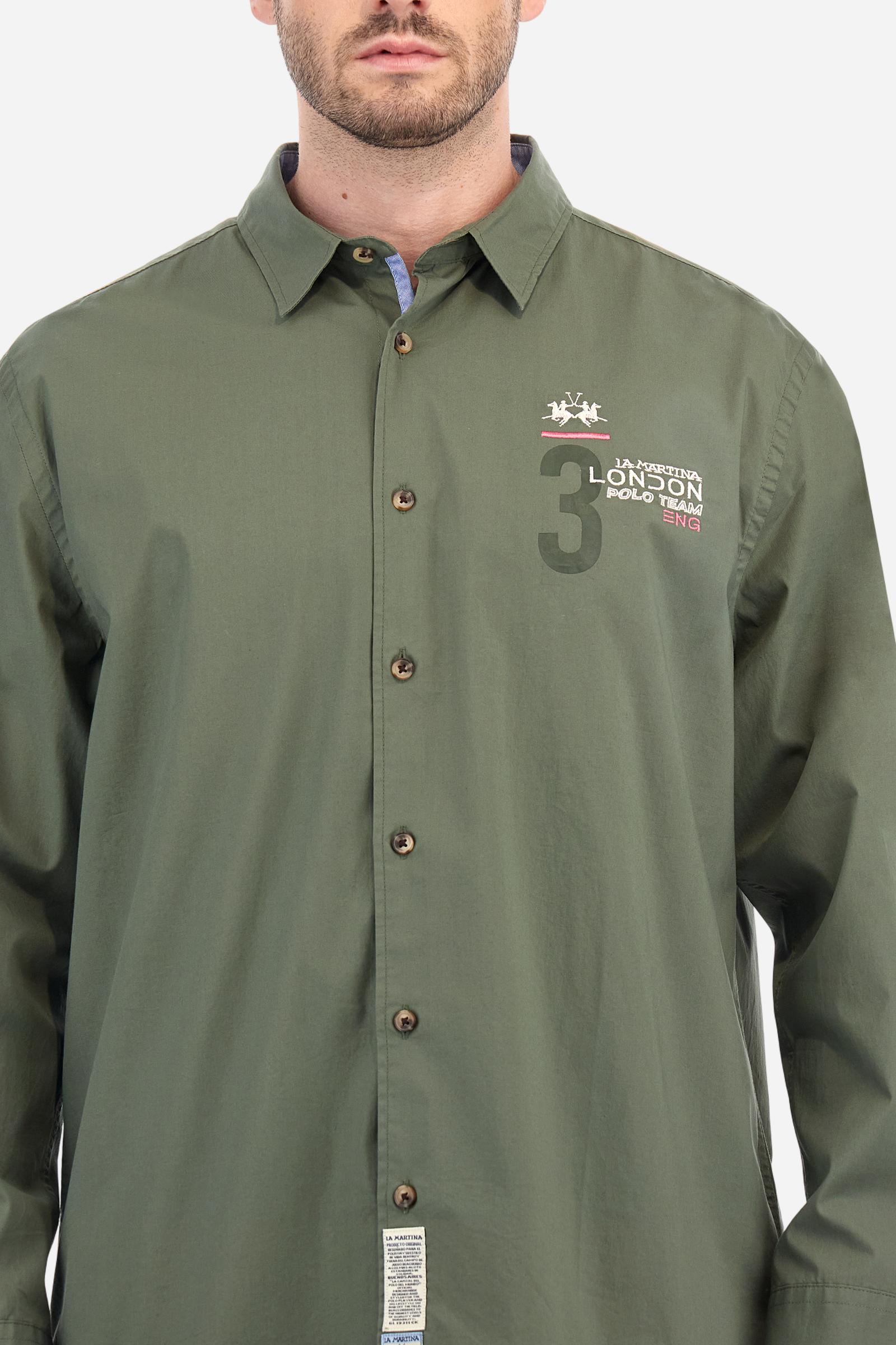 Men's single-colour long-sleeved shirt, made from 100% cotton poplin. Spread collar. Contrasting printed fabric details on the inside of the collar and opening. The numbers on the chest and back graphics are rubberised prints, while the rest of the graphics are embroidered. The logo and La Martina lettering is embroidered on the left chest. The fit is regular. The model is wearing a size L. - Thyme