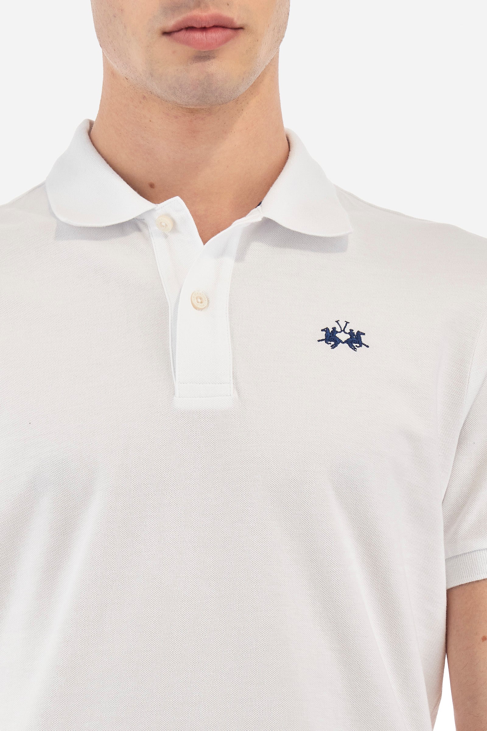 Men's plain-coloured, short-sleeved, regular-fit cotton polo shirt. Contrasting La Martina logo sewn onto the chest. This versatile garment goes perfectly with a pair of jeans from the collection. - Optic White