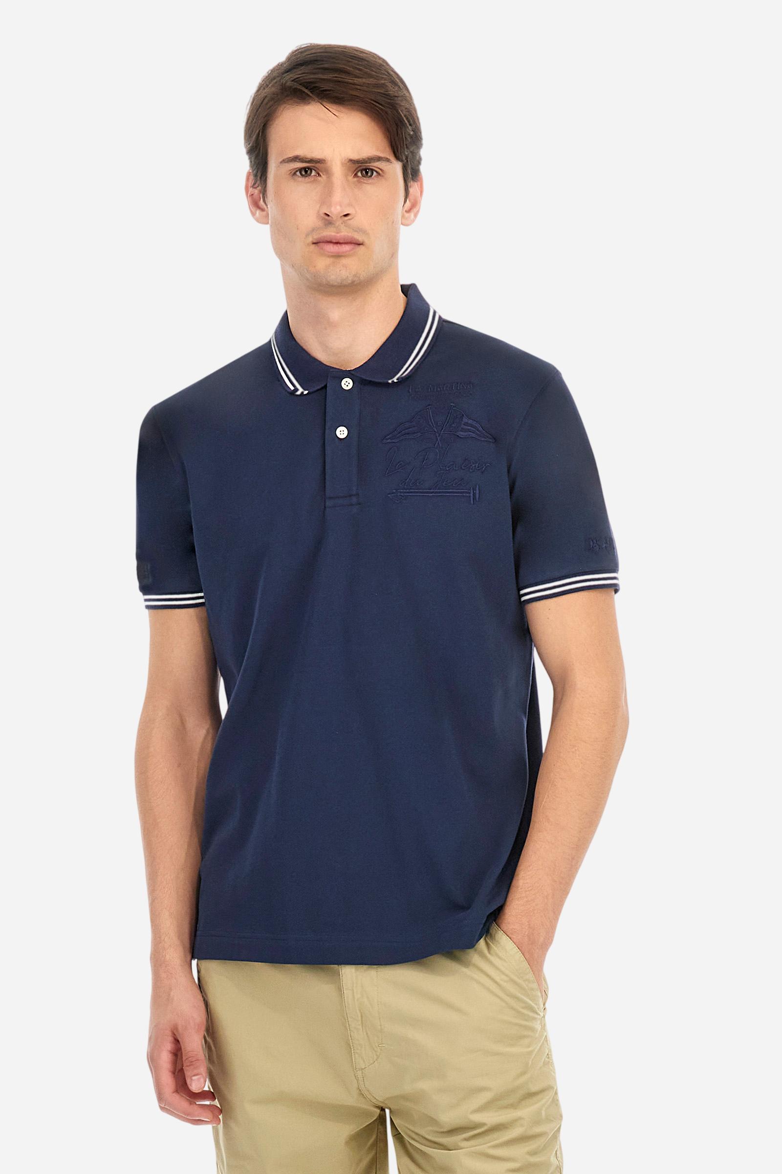 Men's plain short-sleeved polo shirt made from stretch piqué. Two-button fastening. The collar and cuffs are made from two-tone striped ribbed fabric. The inside of the collar and placket feature contrasting fabrics and colours. There is a two-tone striped band around the inside of the collar. The right sleeve and chest are embroidered in tone-on-tone thread. A logo is embroidered on the left sleeve, also using tone-on-tone thread. Regular fit. The model is wearing a size L. - Navy