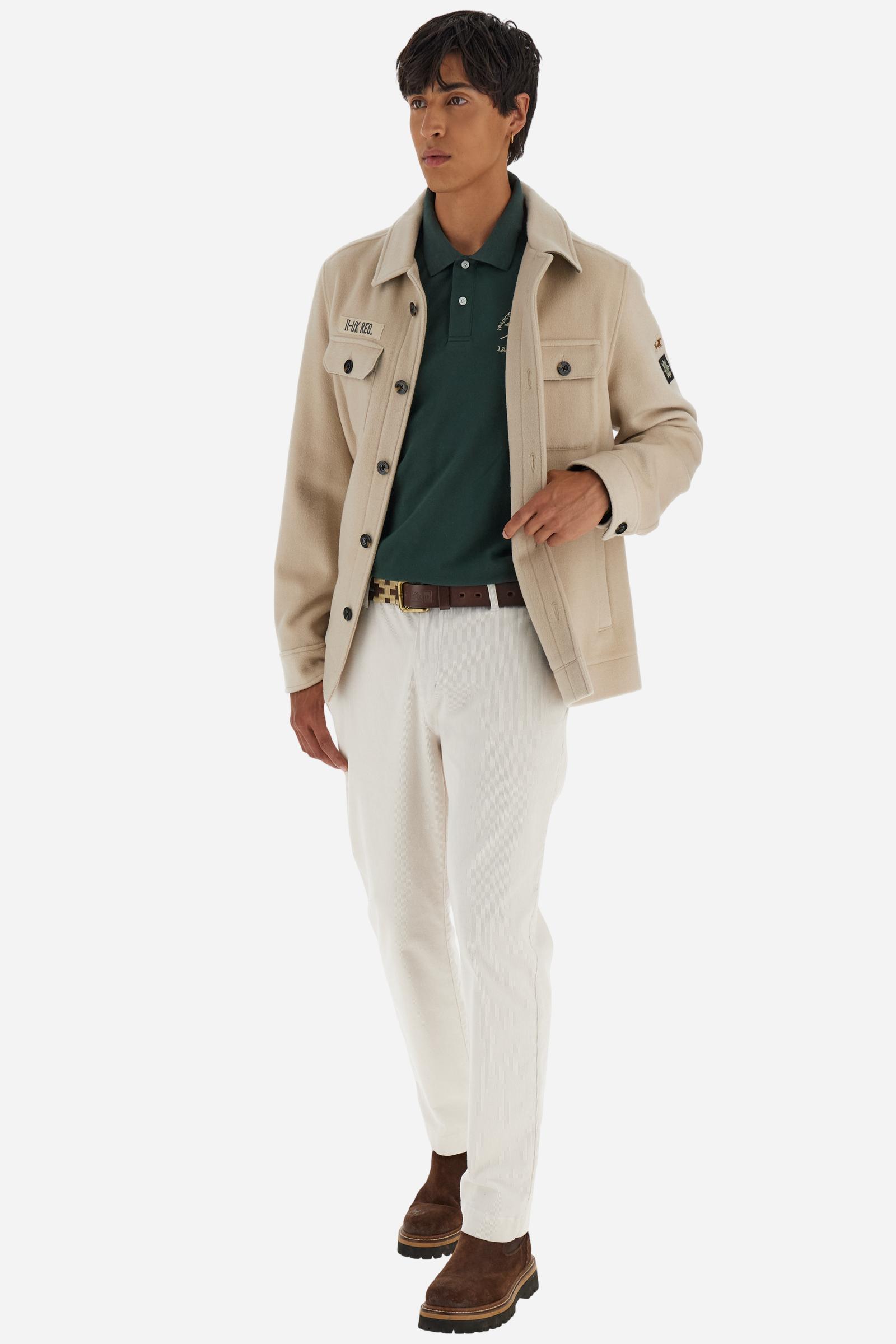 Men's long-sleeved solid colour polo shirt. Made of high-quality stretch Piqué. The collar and cuffs are in solid colour ribbing. The undercollar features a print of the iconic La Martina lettering in a contrasting colour. Featuring a logo embroidered on the chest in a contrasting colour. On the back at the bottom, the guarantee label typical of the brand's iconic models is applied. Regular fit. The model is wearing a size L. - Sycamore