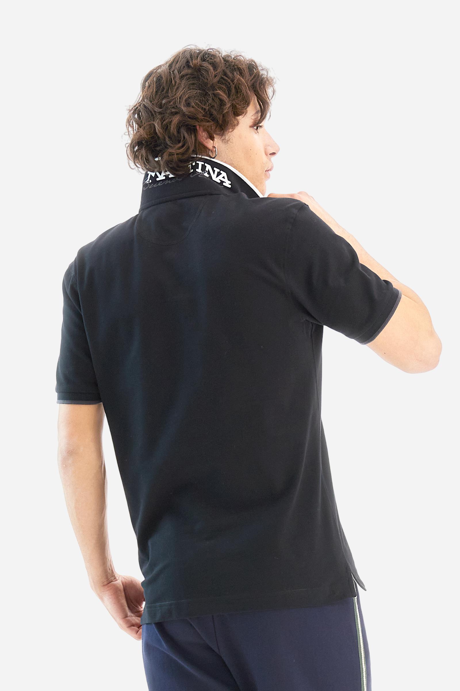 Short-sleeved, single-colour men's polo shirt made of stretch cotton piqué. Fastens with two buttons. The collar and cuffs are ribbed, and there is a colour-contrasting trim at the bottom of the collar. Inside the collar there is a grosgrain ribbon of a different shade. The logo is embroidered on the chest in a contrasting colour. The fit is slim. The model is wearing a size L. - Black