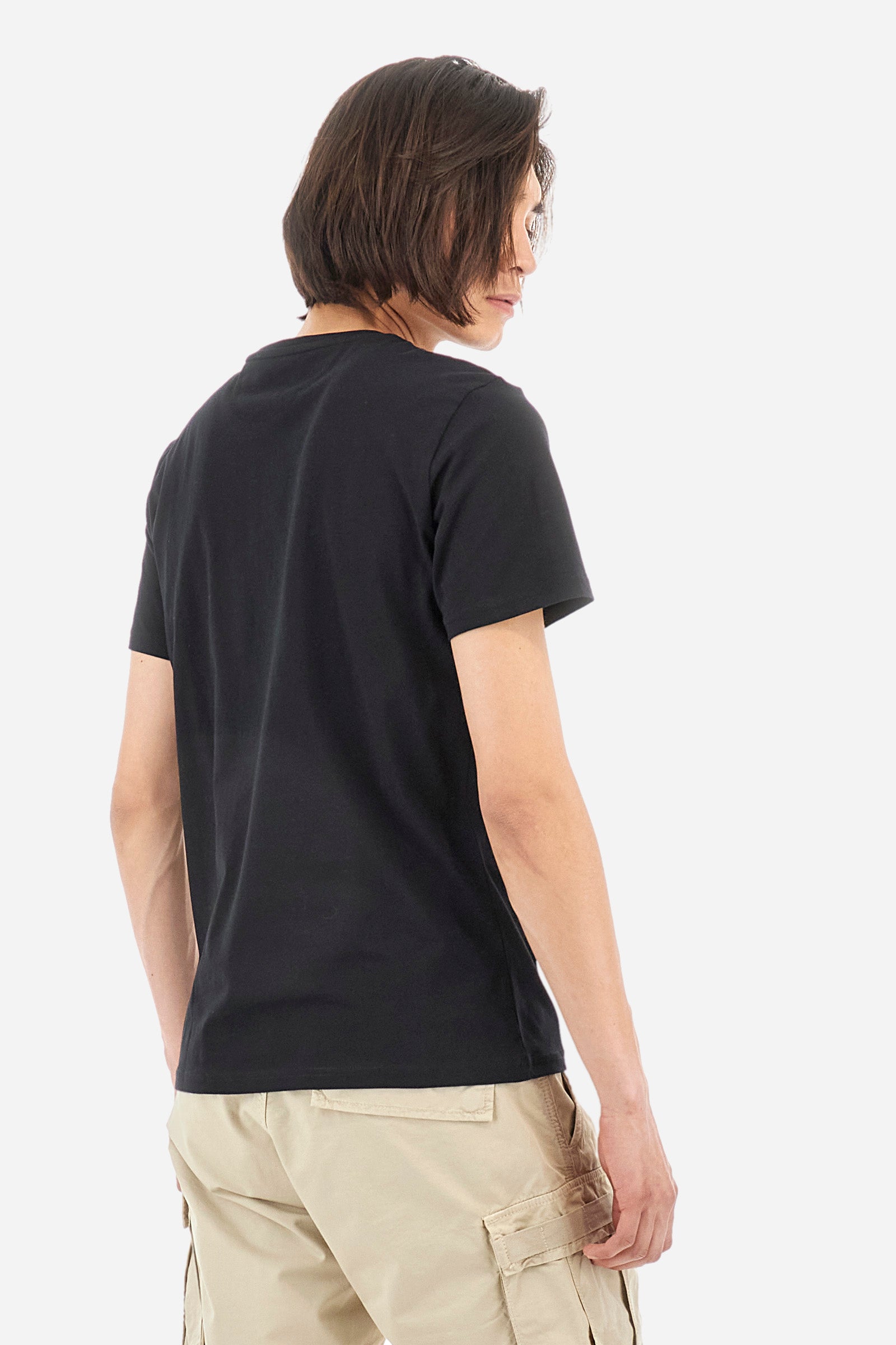 Men's short-sleeved T-shirt with crew neck and solid colour. It features a large printed logo on the front and is made of 100% cotton with a regular fit. It can be combined with trousers for a casual and modern look. The model is 187 cm tall and wears a size L. - Black