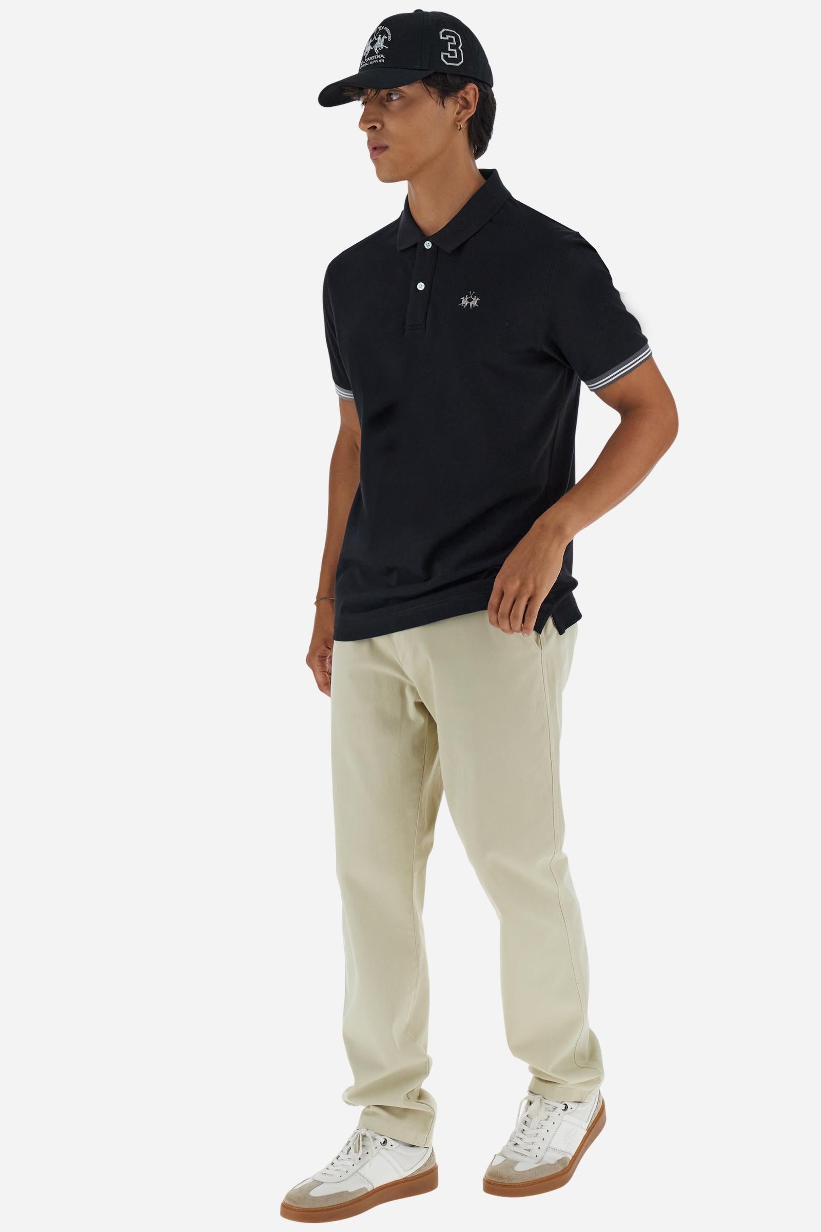 Men’s short-sleeve polo in high-quality stretch cotton piqué, ensuring excellent breathability and flexibility. Classic ribbed collar, two-button placket with customized buttons. Inner collar enriched with contrast tapes and colors for a modern touch. Multicolored ribbed cuffs with different patterns. Small contrast logo embroidered on the chest. Regular fit. Model wears size L. - Black