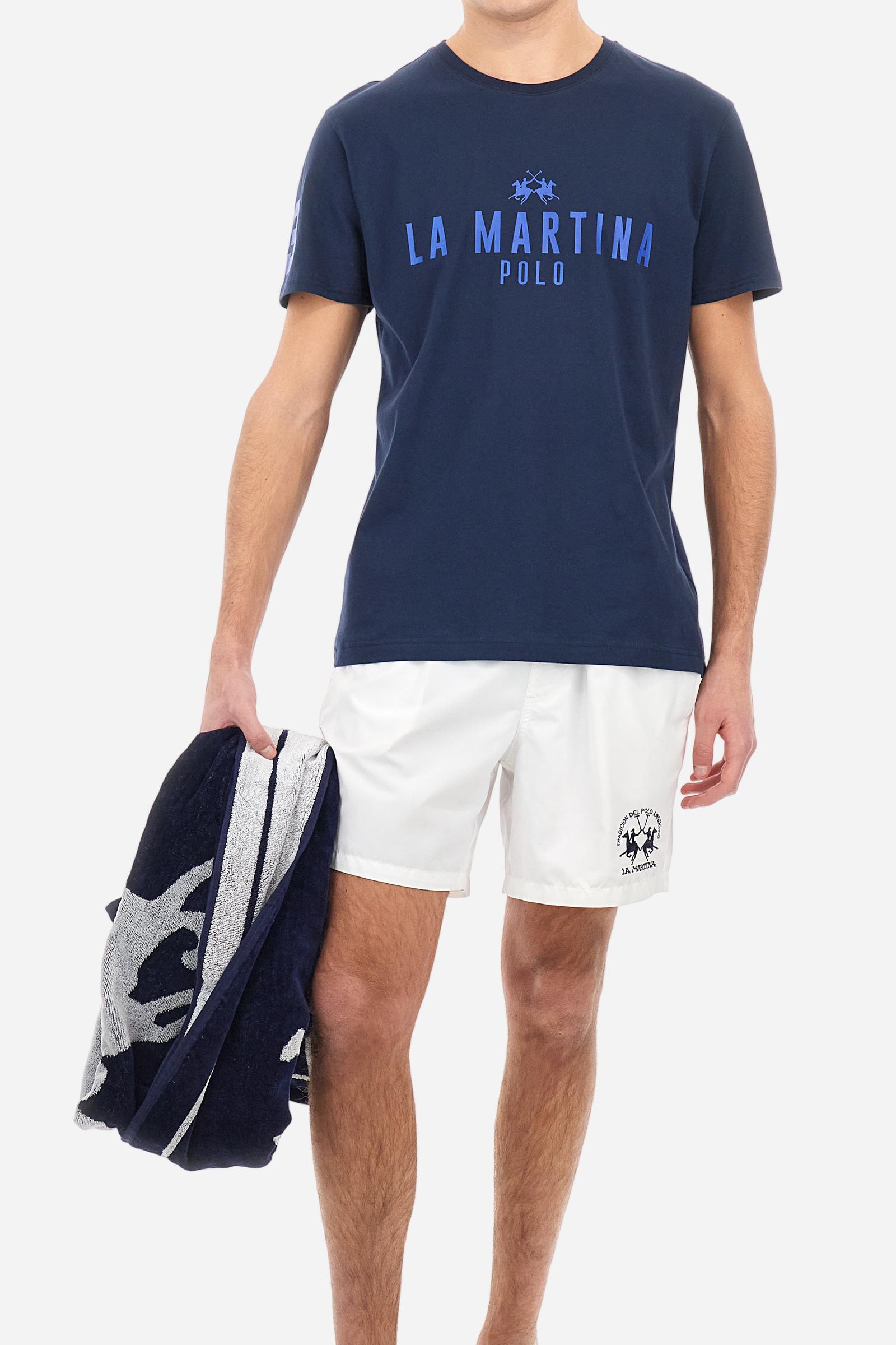 Men's single-colour crew-neck T-shirt with short sleeves, made of 100% cotton. The front features a printed logo and the lettering La Martina Polo. The number 3 is printed on one of the sleeves. Regular fit. The model is wearing a size L. - Navy