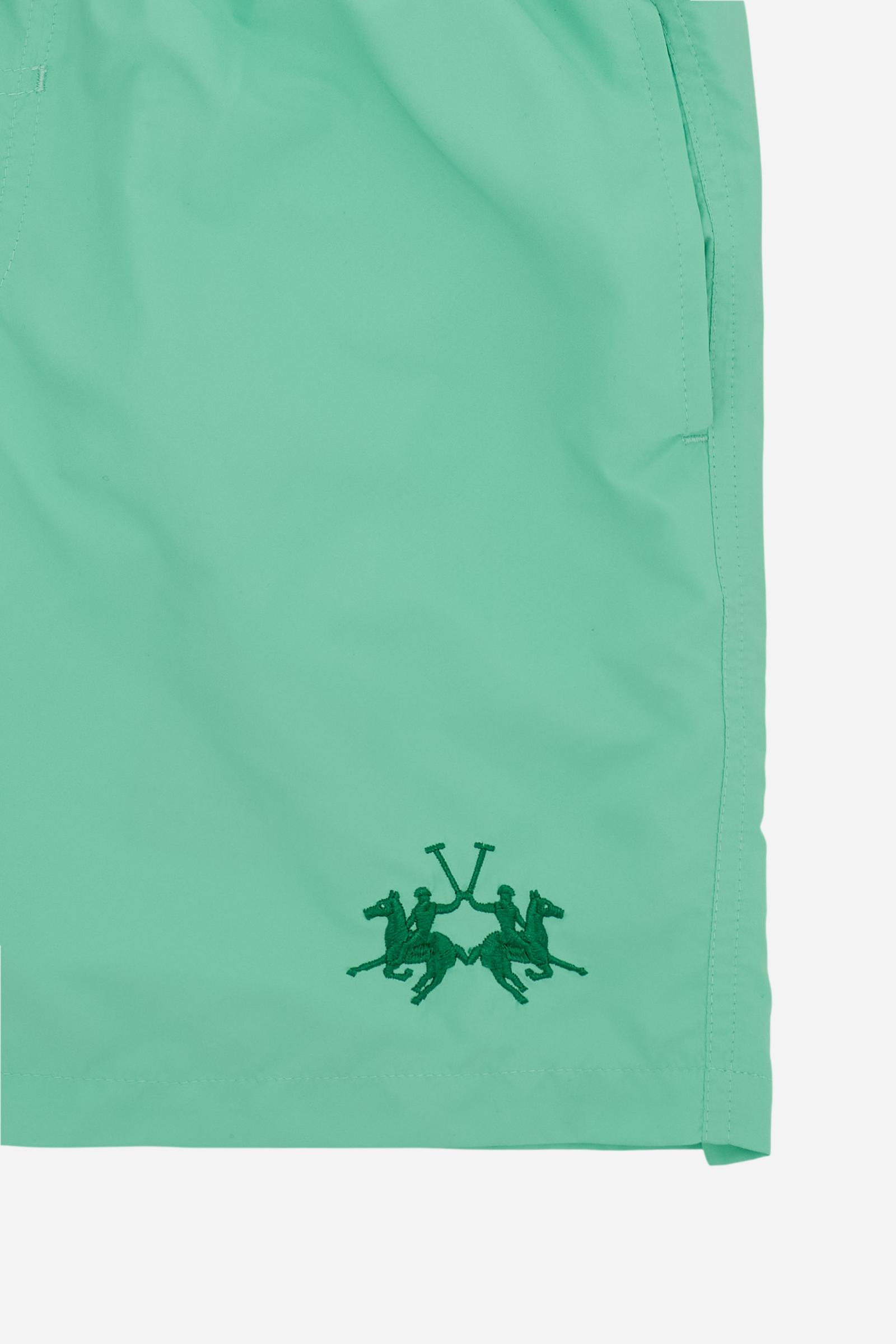 Men’s solid nylon mid-length swim shorts. Regular fit with elasticated waistband, adjustable drawstring, back pocket and embroidered logo. - Opal