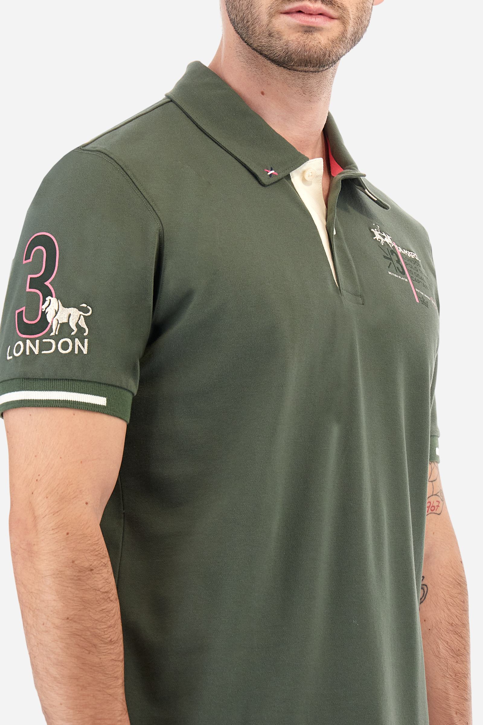 Short-sleeved, single-colour men's polo shirt made of stretch cotton piqué. Fastens with two buttons and internal opening, button side, in contrasting fabric. Ribbed collar and cuffs. The cuffs feature an inlaid detail in a contrasting colour. The graphics on the chest and back are made with mixed techniques: printing and embroidery. The logo is embroidered on the chest, left side. The fit is regular. The model is wearing a size L. - Thyme