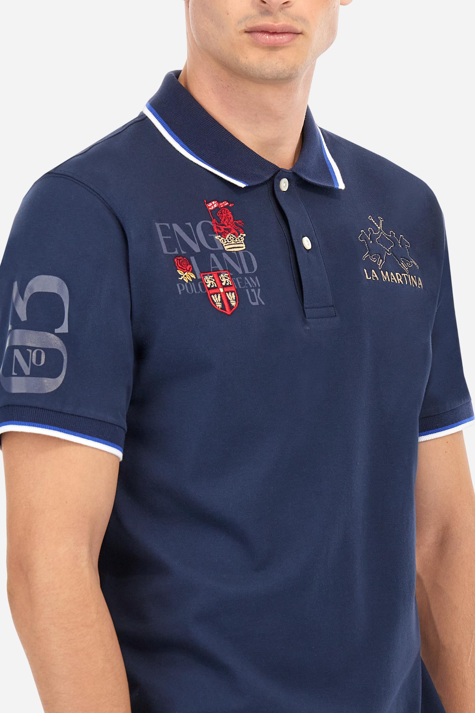 Men's solid color polo shirt, made of slightly elasticated cotton piqué. Two-button closure. Ribbed collar and sleeve hems, with a contrasting two-tone detail at the bottom of the sleeves. The entire garment features details crafted using mixed techniques. Both the front and back display embroidery and prints. The logo and the La Martina lettering are embroidered on the left chest. The fit is regular. The model is wearing size L. - Navy