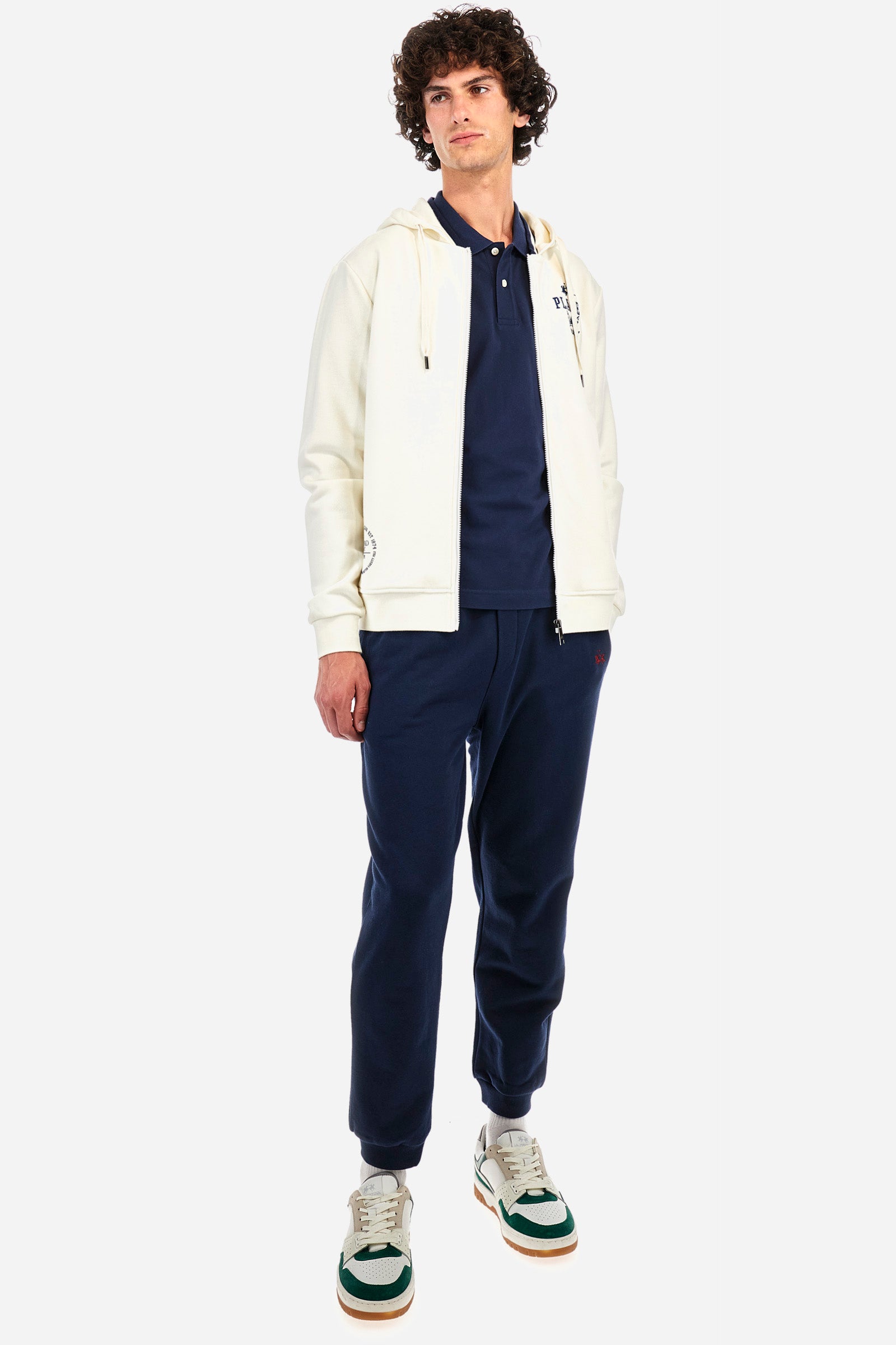 Men's short-sleeved polo shirt in plain stretch cotton. Two-button fastening. The sleeves are finished with contrasting stripes. The logo and lettering associated with the Oxford line are embroidered on the front. Regular fit. The model is wearing a size L. - Navy