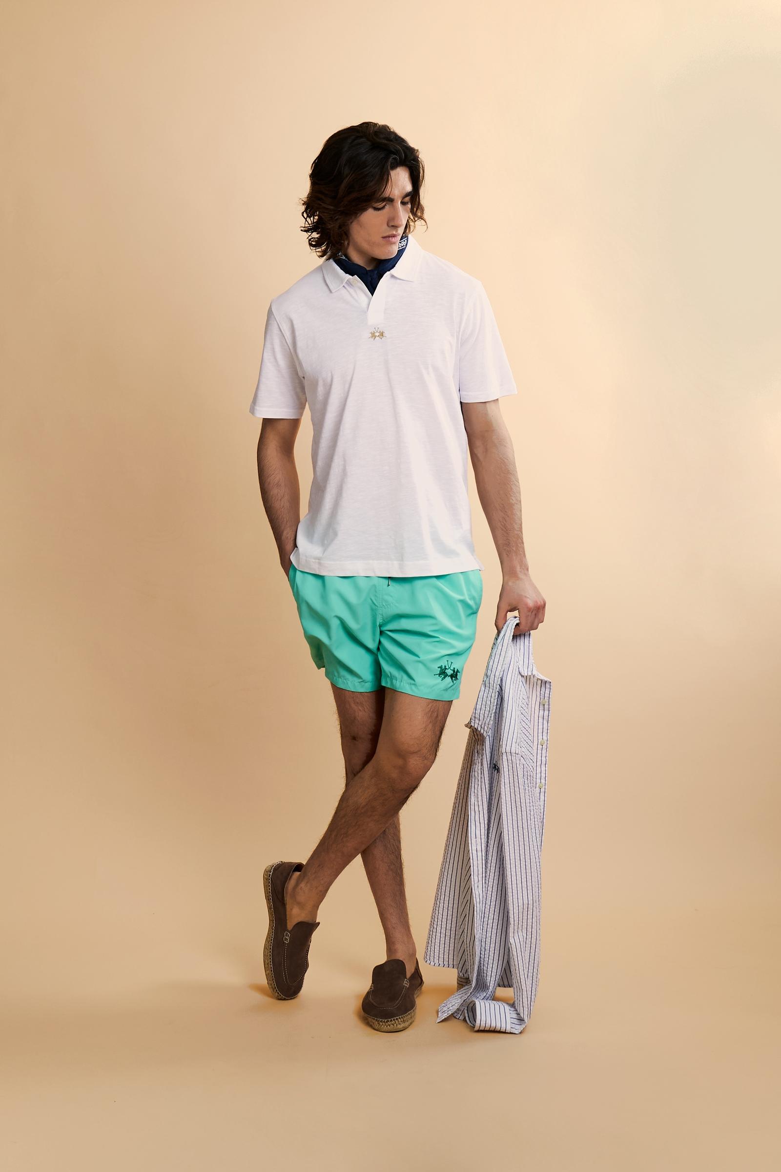 Men’s solid nylon mid-length swim shorts. Regular fit with elasticated waistband, adjustable drawstring, back pocket and embroidered logo. - Opal