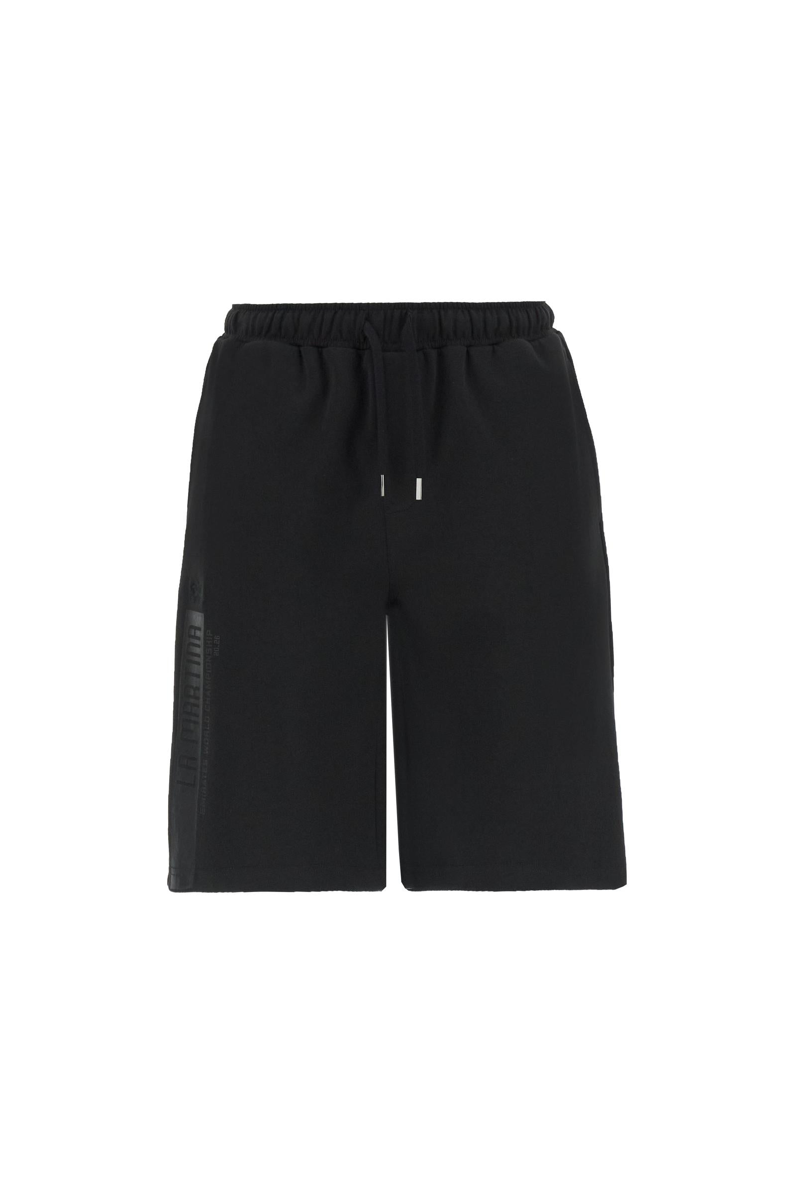 Men’s lightweight interlock bermuda shorts in cotton-blend fabric with a soft technical feel. Modern straight cut above the knee with elastic waistband and external drawstring. Rear patch pocket in contrast fabric with metal stud detail. High-density rubberized side print “La Martina” with Emirates World Championship reference, special edition dedicated to Dubai. The model wears size L. - Black