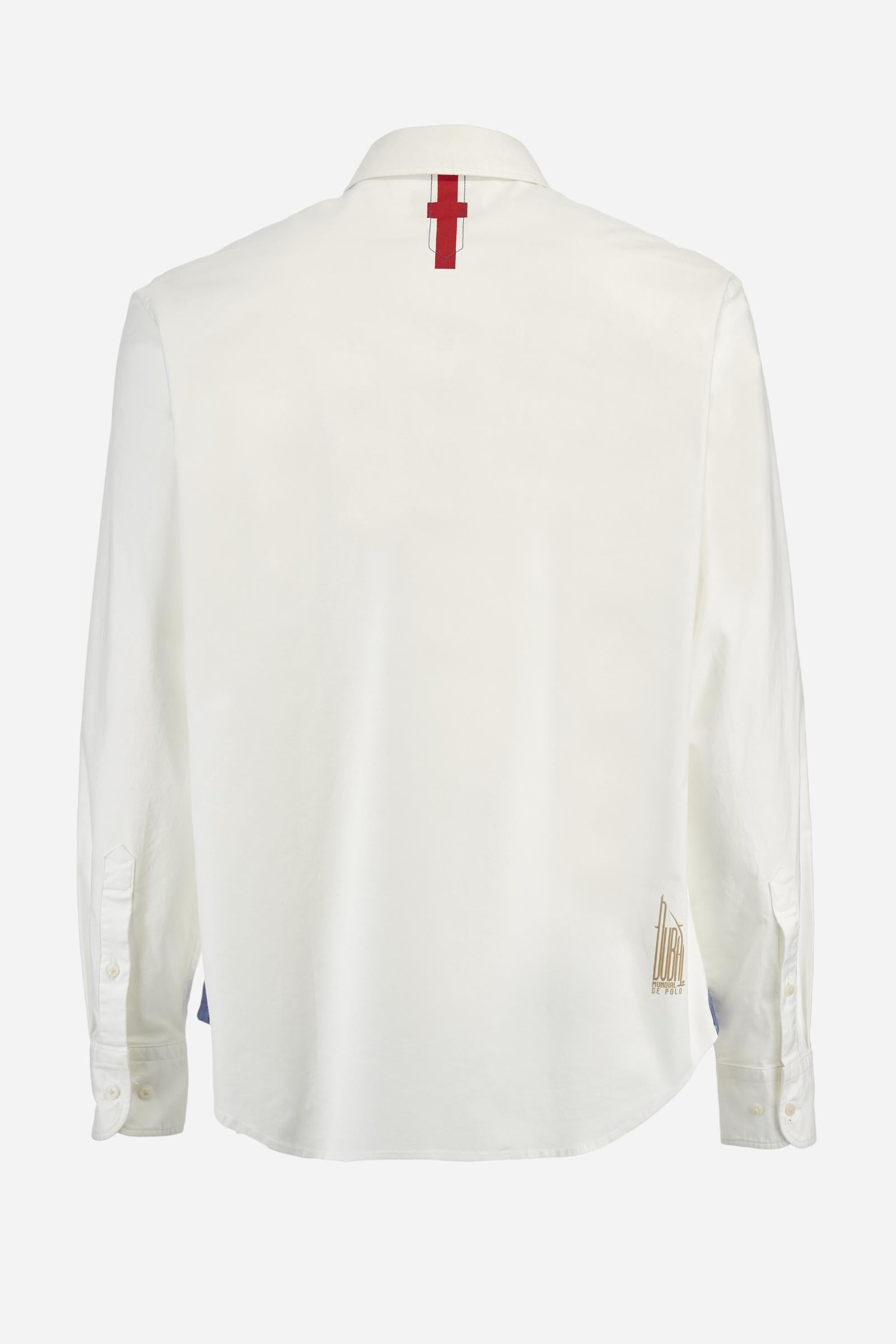 Men's long-sleeved plain shirt made from 100% Oxford cotton. The button-down collar is finished with a second button printed with the English flag. The multicoloured embroidery on the chest, over the heart, includes lettering, numbers and the logo, which add a distinctive touch. Regular fit. The model is wearing a size L. - Optic White
