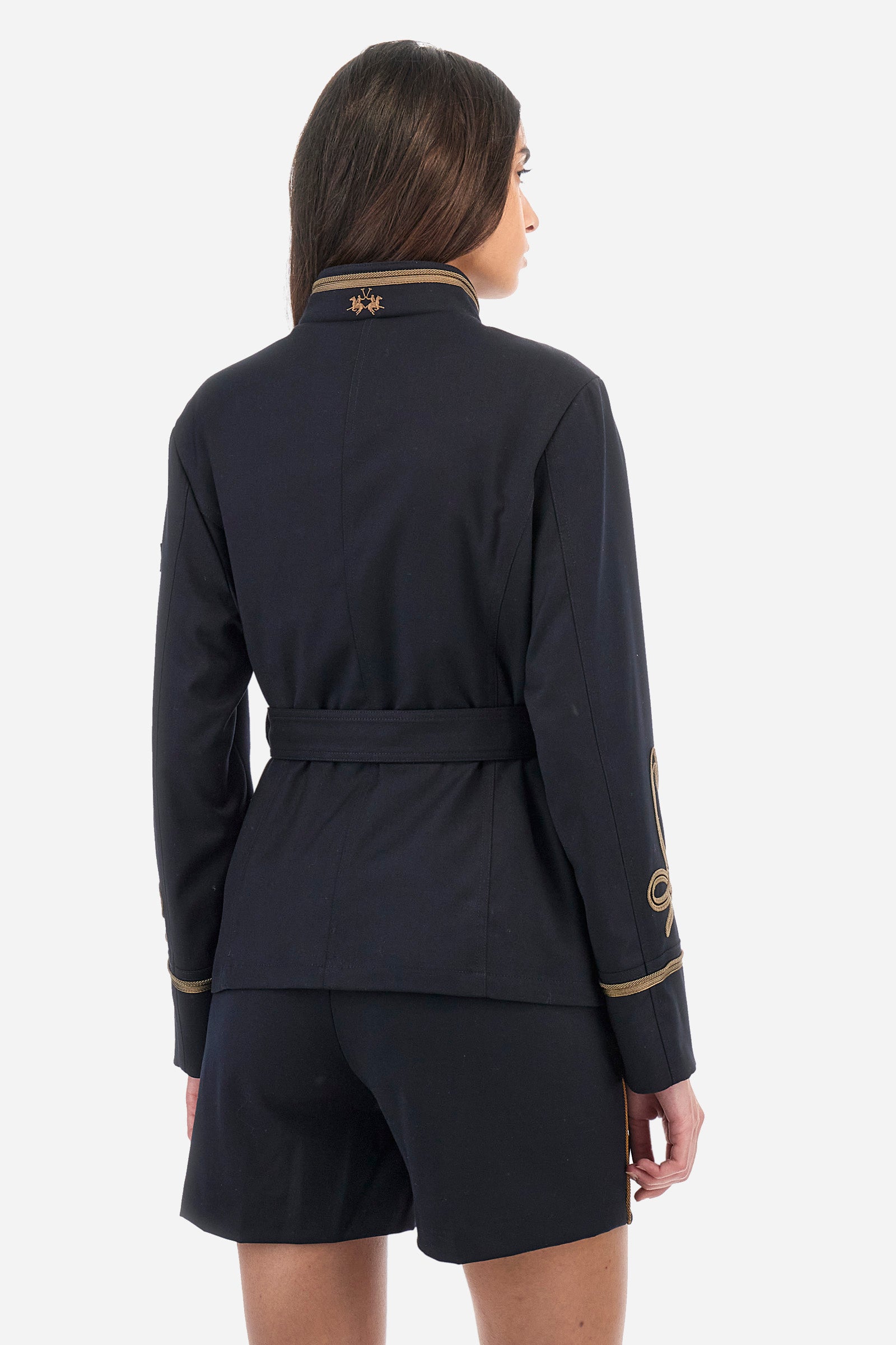 Women's long-sleeved Guards jacket, made from plain synthetic fabric. High neck. Button fastening. Decorations representing the Royal Guards line appear on the sleeves. Double pocket on the front, fastened with buttons. Belt loops at the waist. Regular fit. The model is wearing a size 42. - Navy