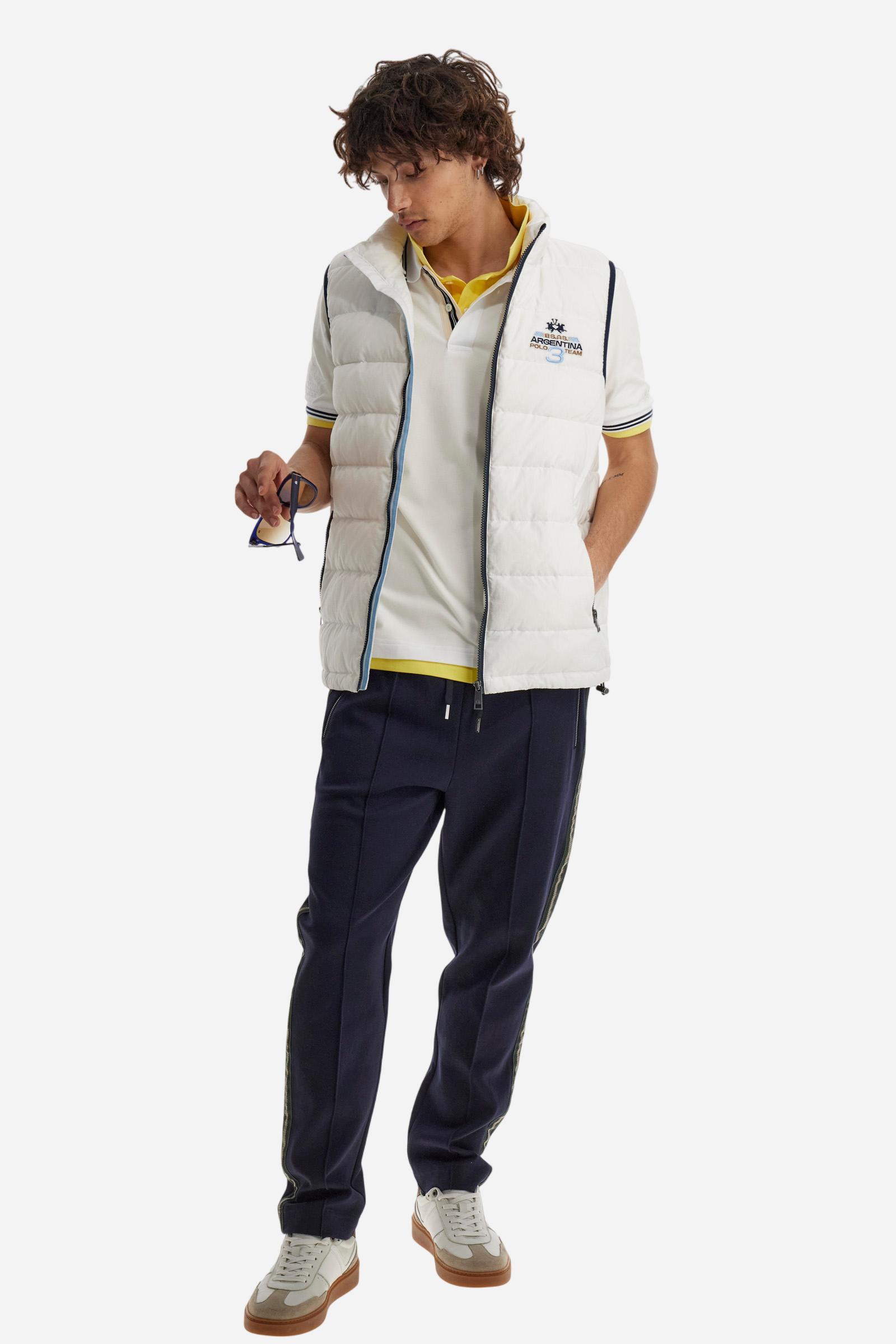 Men's plain short-sleeved polo shirt made from stretch piqué. Two-button fastening. The collar and cuffs are made from two-tone striped ribbed fabric. The inside of the collar and placket feature contrasting fabrics and colours. There is a two-tone striped band around the inside of the collar. The right sleeve and chest are embroidered in tone-on-tone thread. A logo is embroidered on the left sleeve, also using tone-on-tone thread. Regular fit. The model is wearing a size L. - Optic White