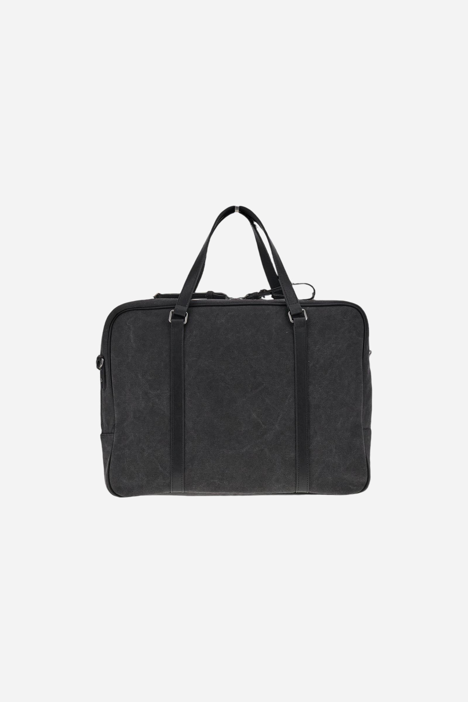 Semi-rigid work bag in washed canvas with smooth leather details, practical and roomy, ideal for work and daily commuting. Closed with a top zip, it includes a detachable shoulder strap and multiple pockets for added functionality. The hot-stamped logo on the leather tag completes the model. Dimensions:40 x 31 x 9 - Black