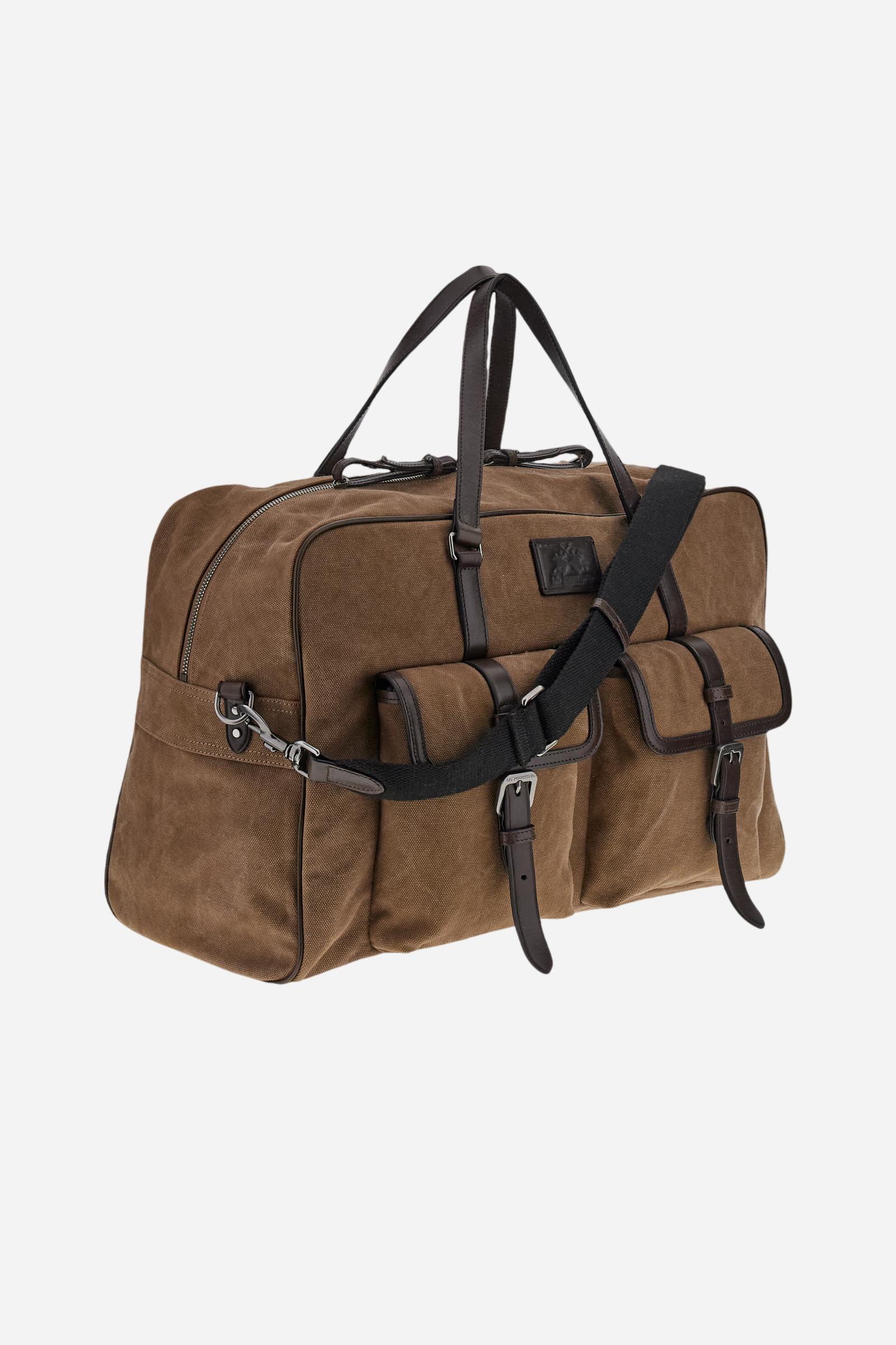 Travel bag in washed canvas and leather. Large and practical, with removable shoulder strap and big front pockets with buckles. - COCOA