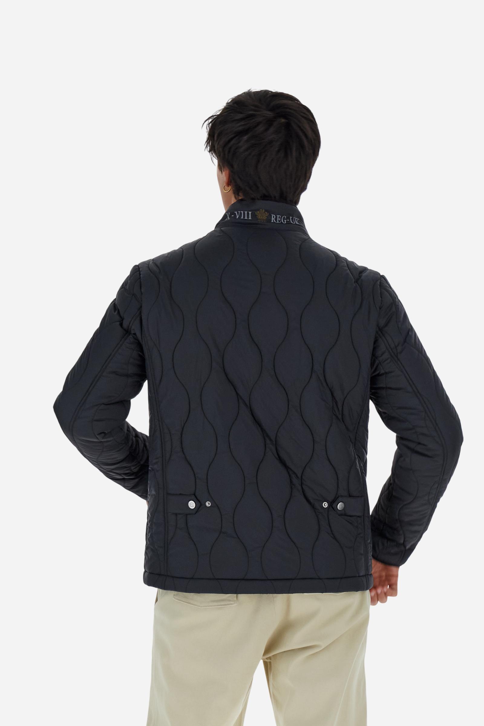 Men’s quilted nylon husky jacket with high collar. Front closure with customized zip and large faux-leather buttons. Interior lined with striped bicolor polyester. Contrast details on the inside (pockets, profiles, back-neck tab). Clean design with chest pocket closed by zip and vertical side pockets. Adjustable back straps with metal snap buttons. Logo patches on the sleeves and multicolor embroidered lettering on the outer collar. Part of the Guards capsule. Regular fit. Model wears size L. - Black