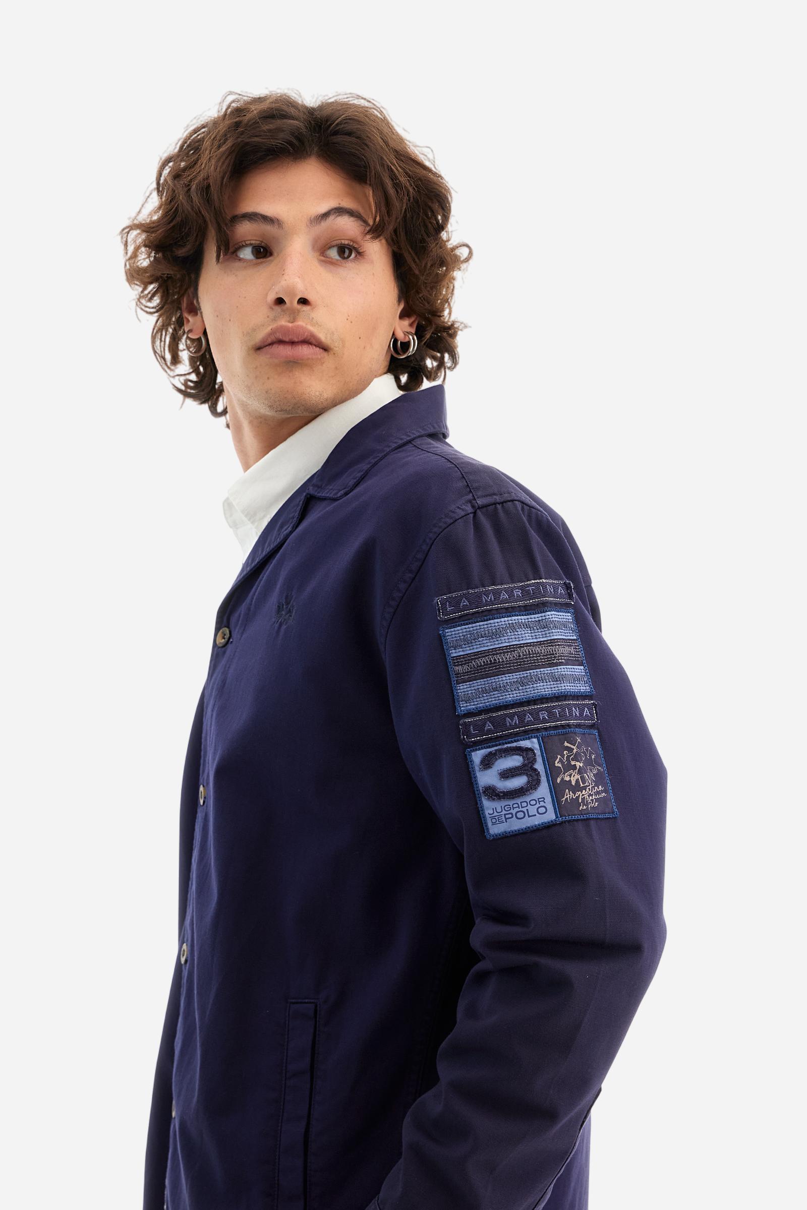 Men's single-colour long-sleeved overshirt made of 100% cotton slub twill. Bowling collar and jacket opening with inside placket, fastening with imitation horn buttons.On the shoulder and chest the embroidery is in tone with the garment, Argentina lettering embroidered on one shoulder. There are several patches applied on the left sleeve. A tone-on-tone logo is embroidered on the front. Regular fit. The model is wearing a size L. - Deep Cobalt