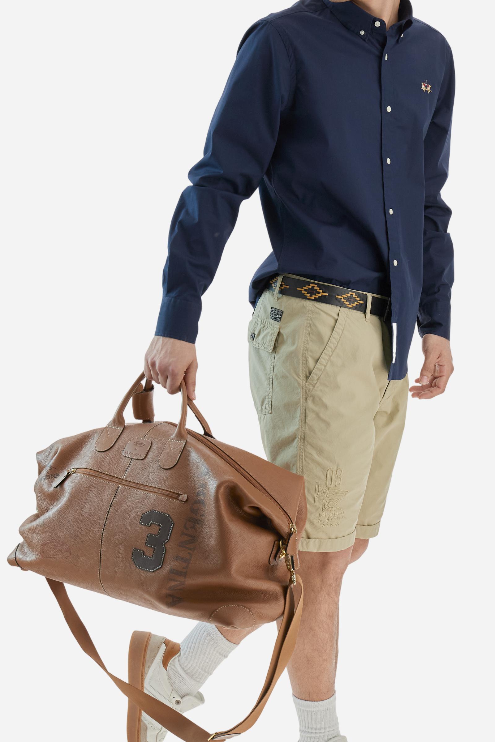 Men's plain long-sleeved shirt made from stretch cotton poplin for a comfortable fit. Featuring a button-down collar and woven labels at the bottom of the opening. A multicoloured logo is embroidered on the chest, over the heart, in contrasting thread. The slim fit ensures a sleek and modern look. The model is wearing a size L. - Navy