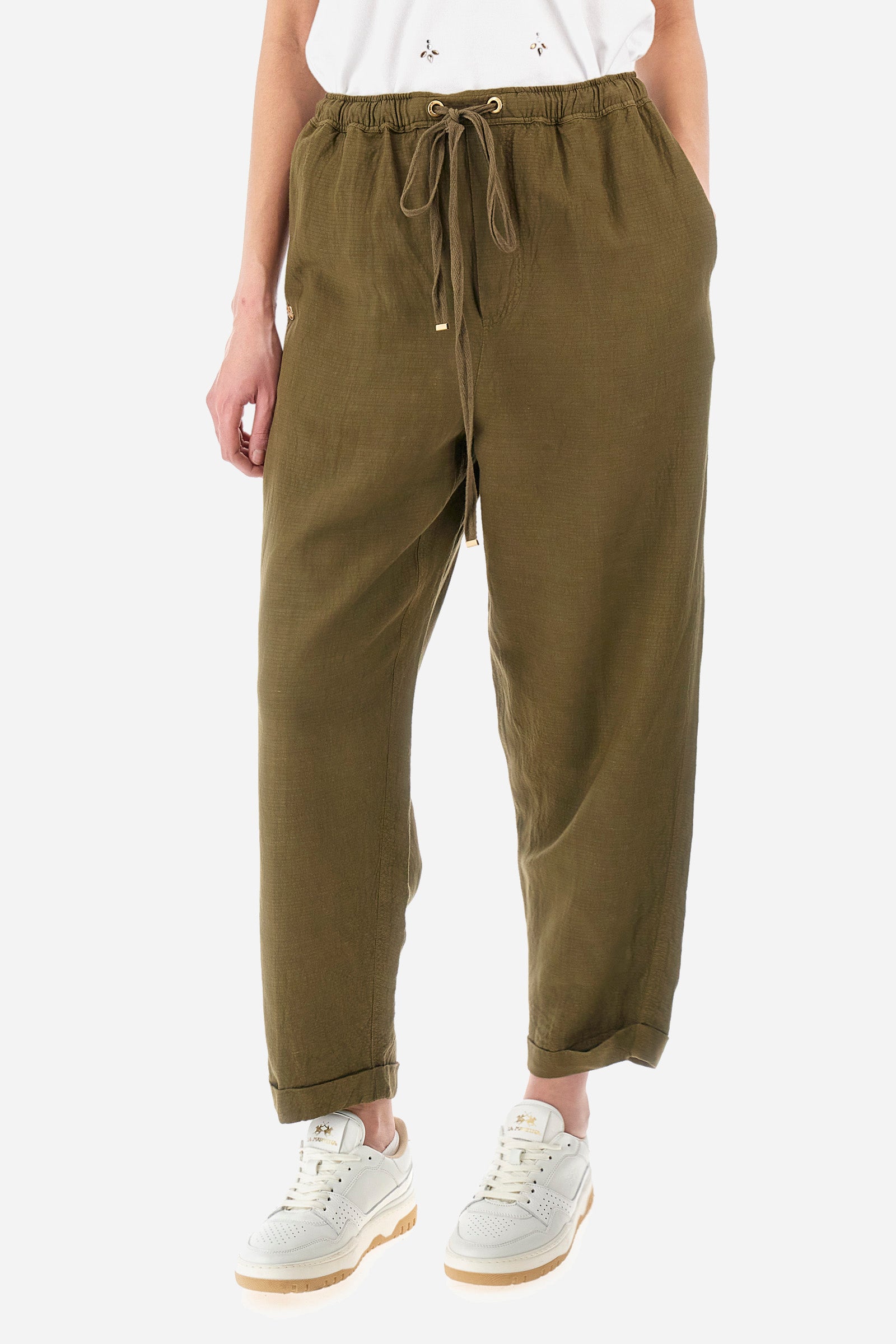 Women’s trousers in solid color, made of oxford fabric. Drawstring waist along with laces to comfortably adjust the closure. Two front pockets and two back welt pockets. The logo is applied on the back and on a metal plate sewn into the front. The fit is regular. The model wears a size 2. - Military Olive