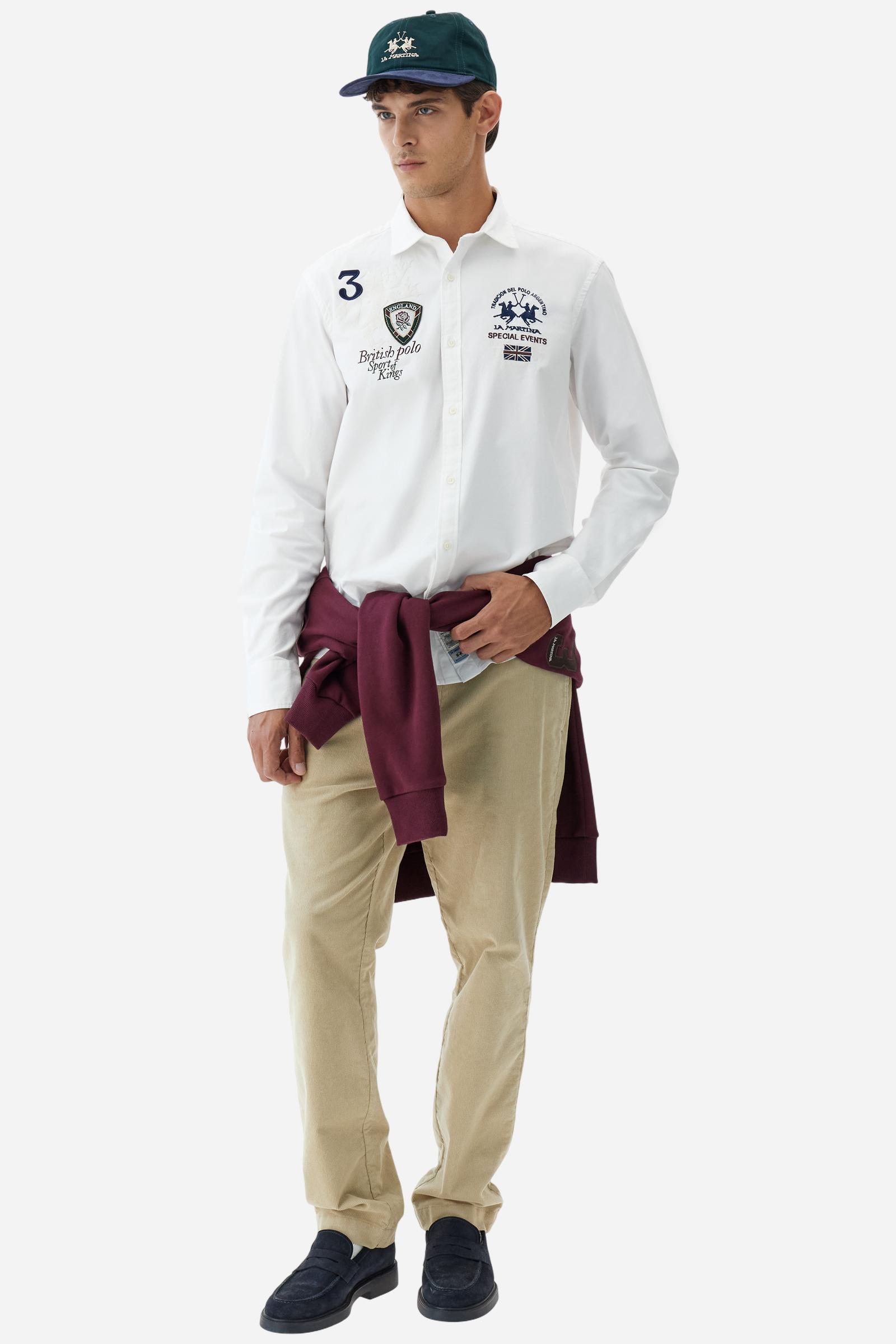 Classic men's long-sleeved shirt in stretch cotton Oxford, solid colour. Finished with a French collar and interior regimental-pattern fabric details. Chest features multicolour prints and embroideries inspired by British Polo, including the large team logo embroidered in contrast. Regular fit ensuring comfort and enhancing any physique. Model wears size L. - Optic White