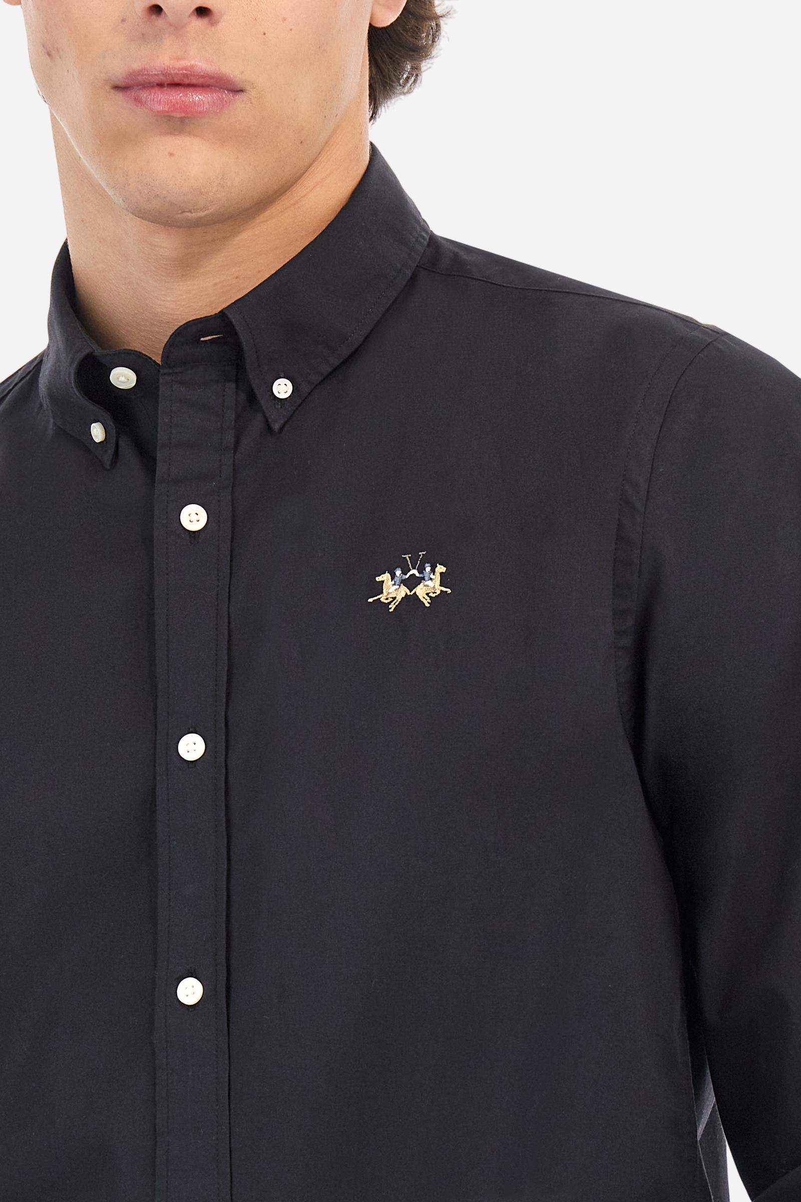 Men's plain long-sleeved shirt made from stretch cotton poplin for a comfortable fit. Featuring a button-down collar and woven labels at the bottom of the opening. A multicoloured logo is embroidered on the chest, over the heart, in contrasting thread. The slim fit ensures a sleek and modern look. The model is wearing a size L. - Black