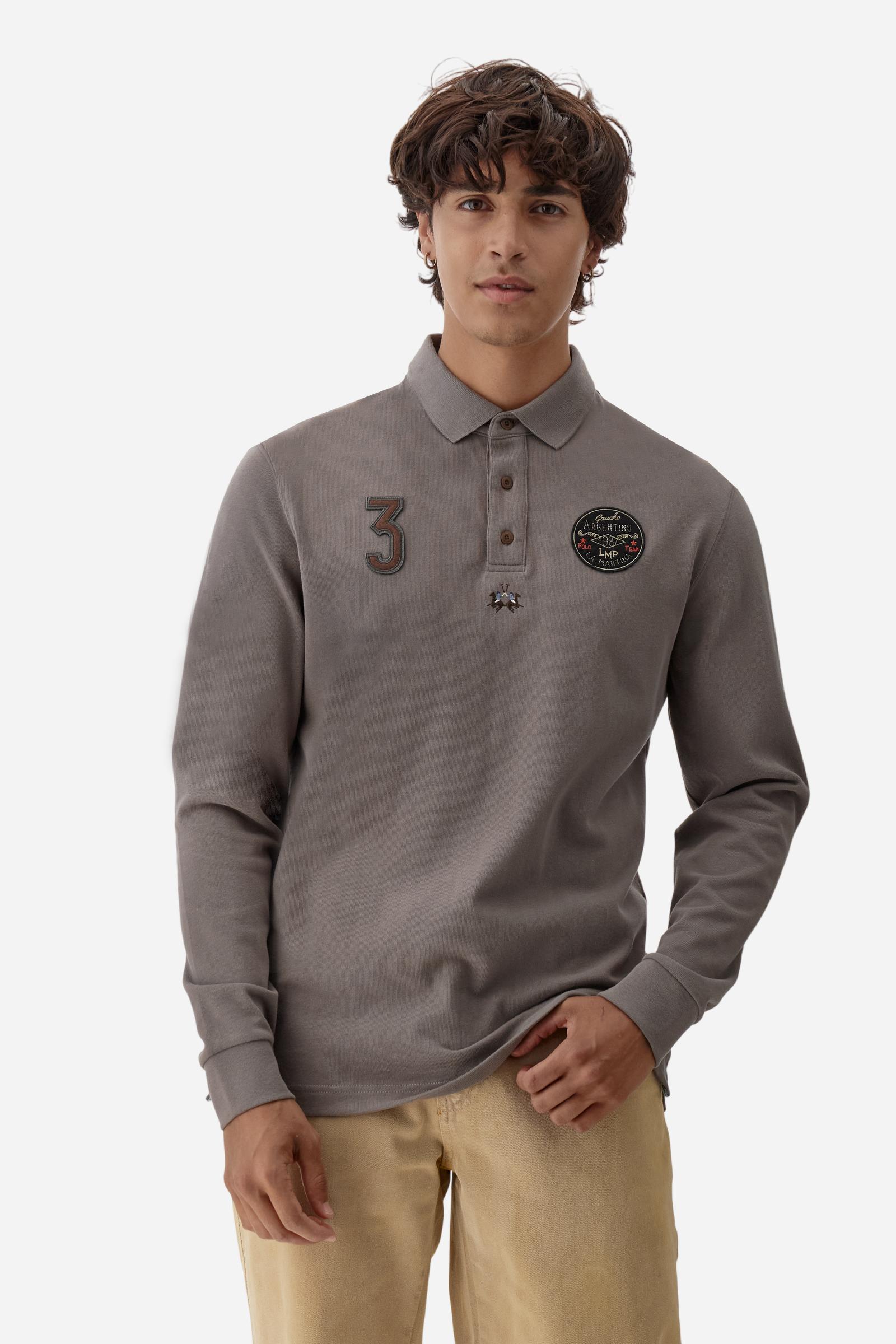 Long-sleeve polo shirt crafted from 100% high-quality cotton jersey. The velvety fabric offers a warm, cozy feel, perfect for cooler seasons. Ribbed collar and cuffs in matching tone, with a three-button personalized placket. A small multicolor embroidered logo sits below the opening, while tonal patches in different shapes and textures, inspired by Argentine culture and Gaucho tradition, decorate the chest and back. Classic regular fit. Model wears size L. - Falcon