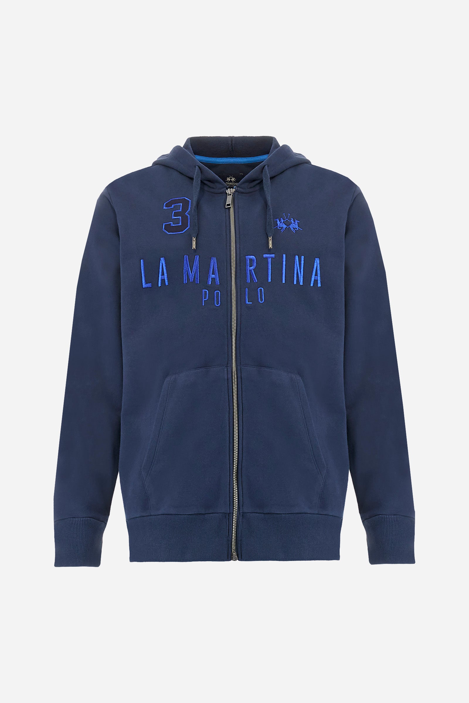 Men's long-sleeved plain sweatshirt made from French terry cotton. Full-zip fastening and hood with adjustable drawstring. On the chest, the La Martina Polo lettering is present as a large, slightly embossed embroidery, while the number 3 is present as a patch made of the same fabric and applied with an embroidered cord in a contrasting colour. The logo is embroidered on the chest, left side. Regular fit. The model is wearing a size L. - Navy