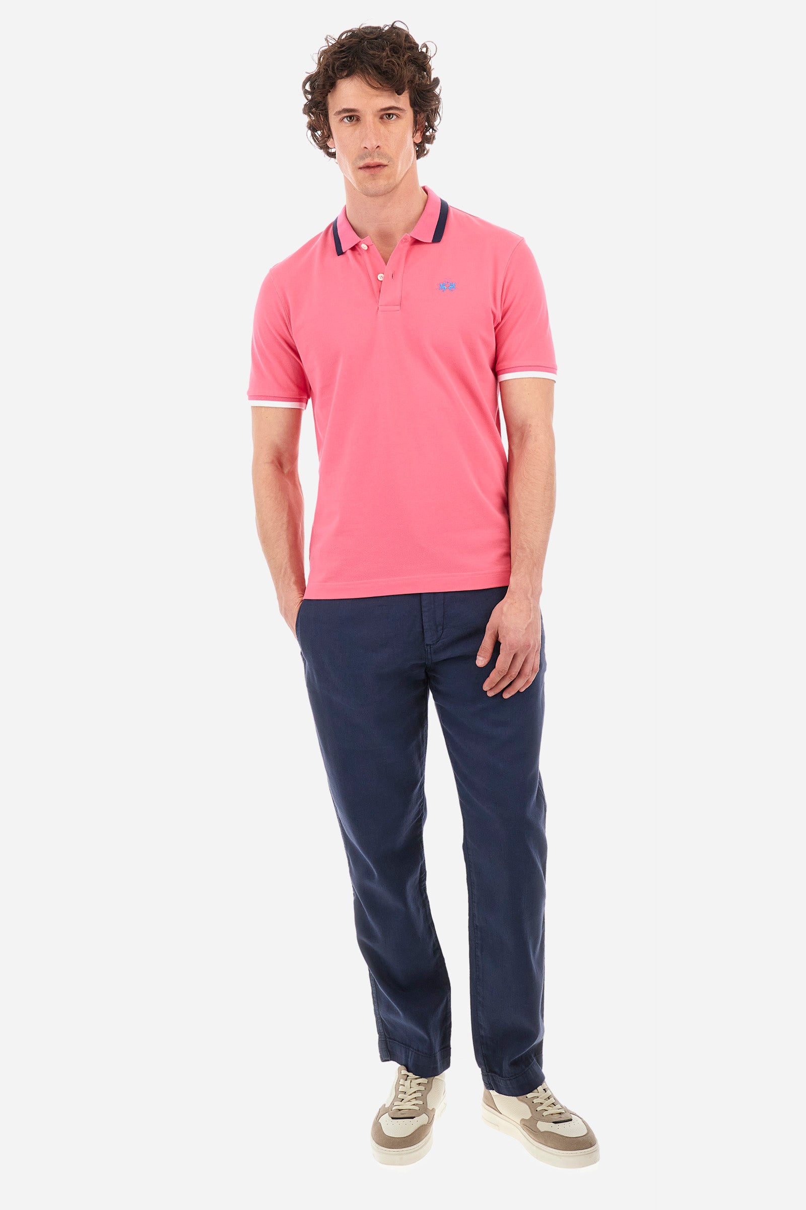 Men's single-colour short-sleeved polo in elasticated cotton. Two-button fastening. Ribbed collar and armholes with a stripe in different shades. The "La Martina" lettering can be found under the collar. Featuring a small logo embroidered on the chest. In a slim fit. The model wears a size L. - Hot Pink