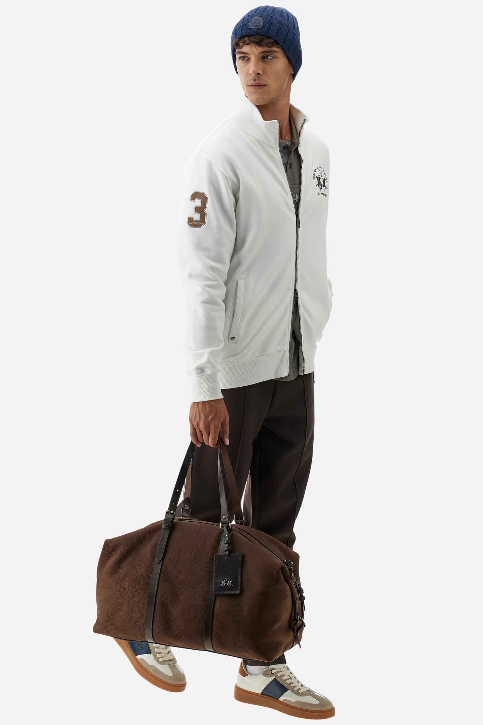 Men's long-sleeved solid colour sweatshirt. It is made of comfortable 100% cotton fleece with a soft-brushed feel. Model with high ribbed neck and front zip opening. Solid colour ribbed cuffs and waistband. The large contrasting brand team logo is embroidered on the chest. A contrasting colour fabric number patch is applied to the right sleeve. The model has a regular fit that offers a comfortable, relaxed silhouette. The model is wearing a size L. - Off White