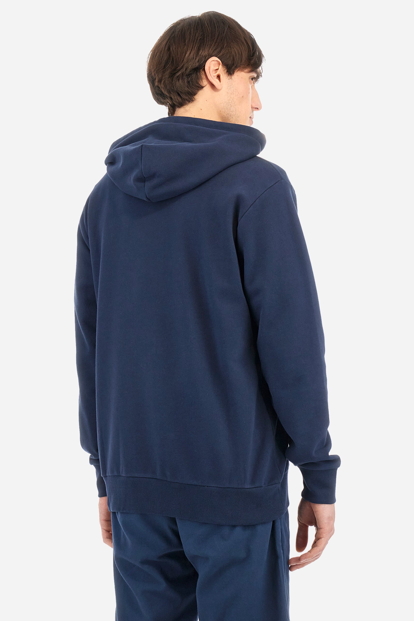 Men's long-sleeved plain sweatshirt made from French terry cotton. Full-zip fastening and hood with adjustable drawstring. On the chest, the La Martina Polo lettering is present as a large, slightly embossed embroidery, while the number 3 is present as a patch made of the same fabric and applied with an embroidered cord in a contrasting colour. The logo is embroidered on the chest, left side. Regular fit. The model is wearing a size L. - Navy