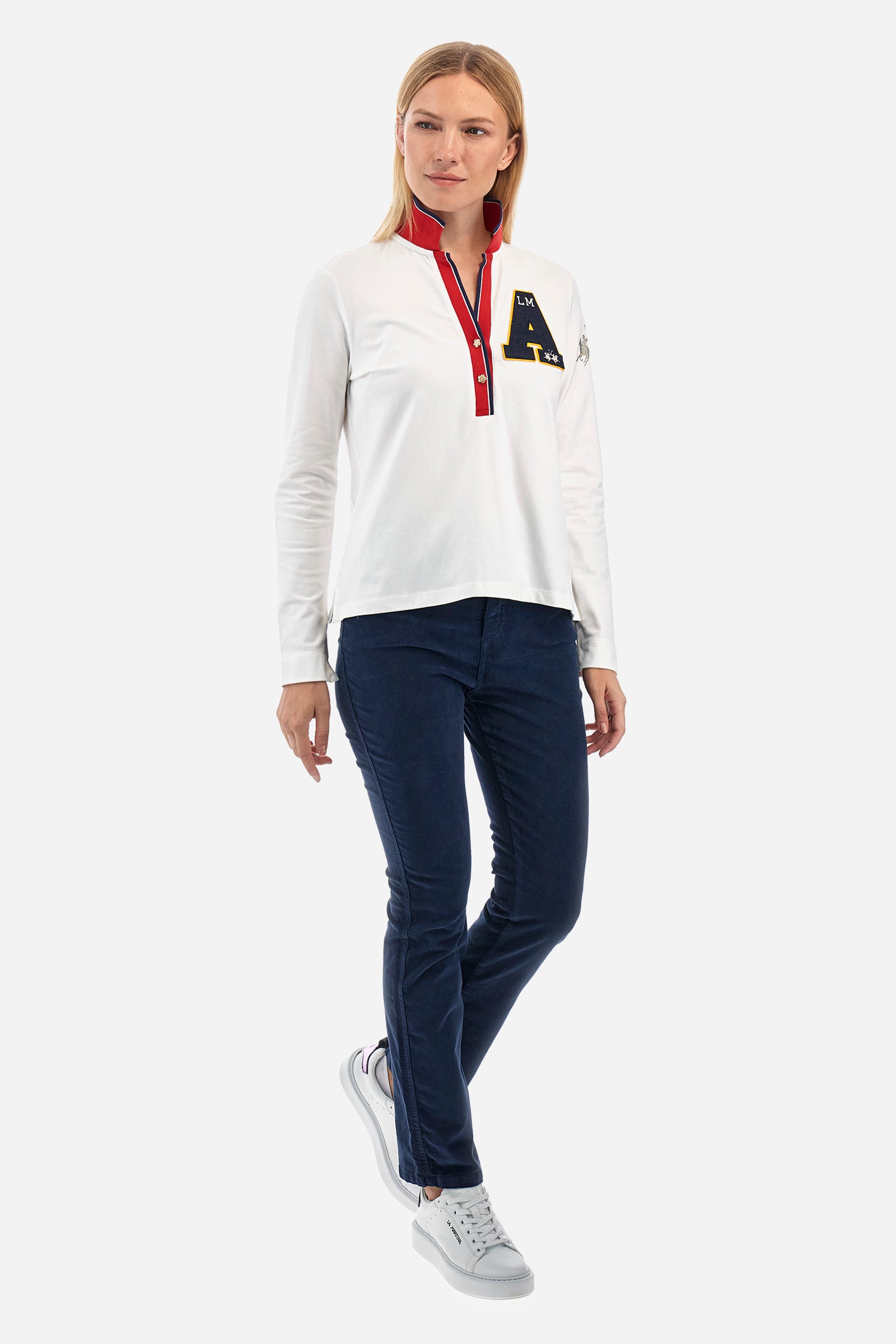 Women's long-sleeved polo shirt in stretch cotton, with regular lines in the Polo Academy style. The collar is classic, with a V neckline and double jewel button. Available in solid colour with different fun prints in contrasting colours on the garment. Featuring a rhinestone logo on the sleeve. This garment is designed for the practical and sporty woman who seeks comfort and style without sacrificing quality. Suitable for any occasion. The model is 174 cm tall and wears a size 2. - Off White