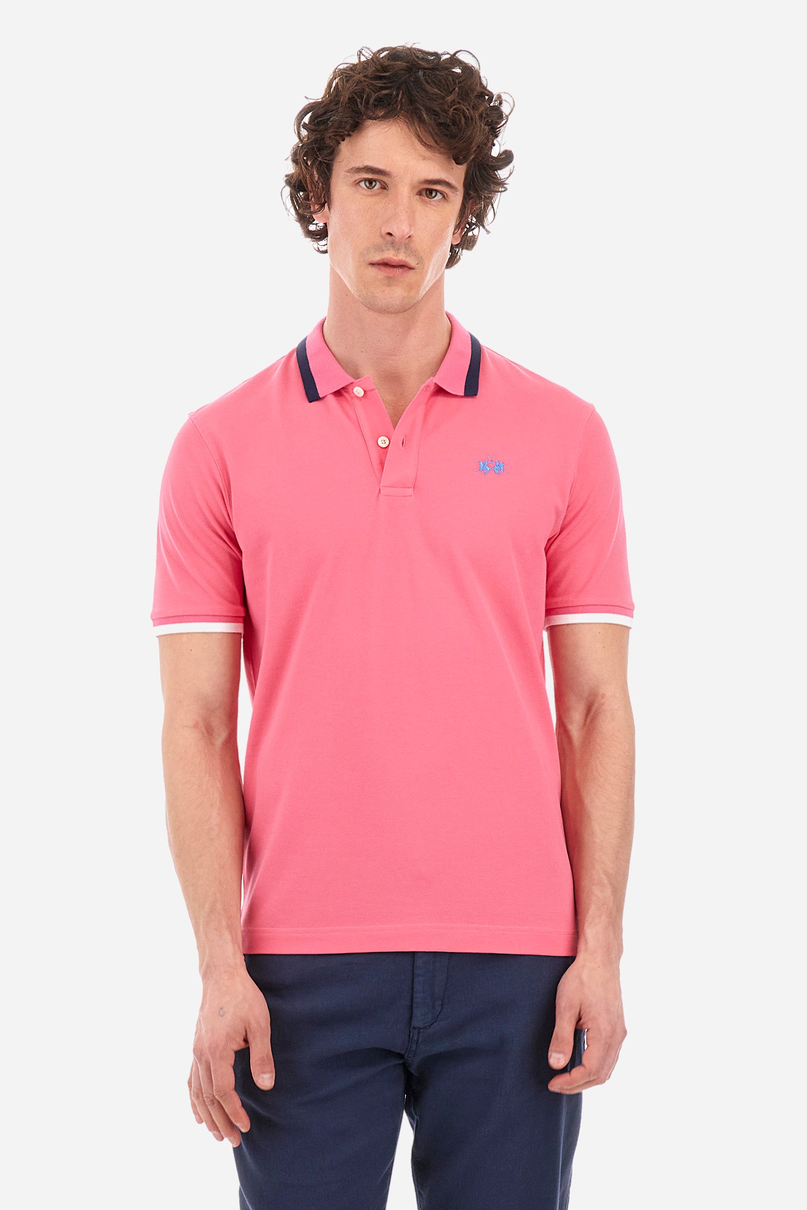 Men's single-colour short-sleeved polo in elasticated cotton. Two-button fastening. Ribbed collar and armholes with a stripe in different shades. The "La Martina" lettering can be found under the collar. Featuring a small logo embroidered on the chest. In a slim fit. The model wears a size L. - Hot Pink