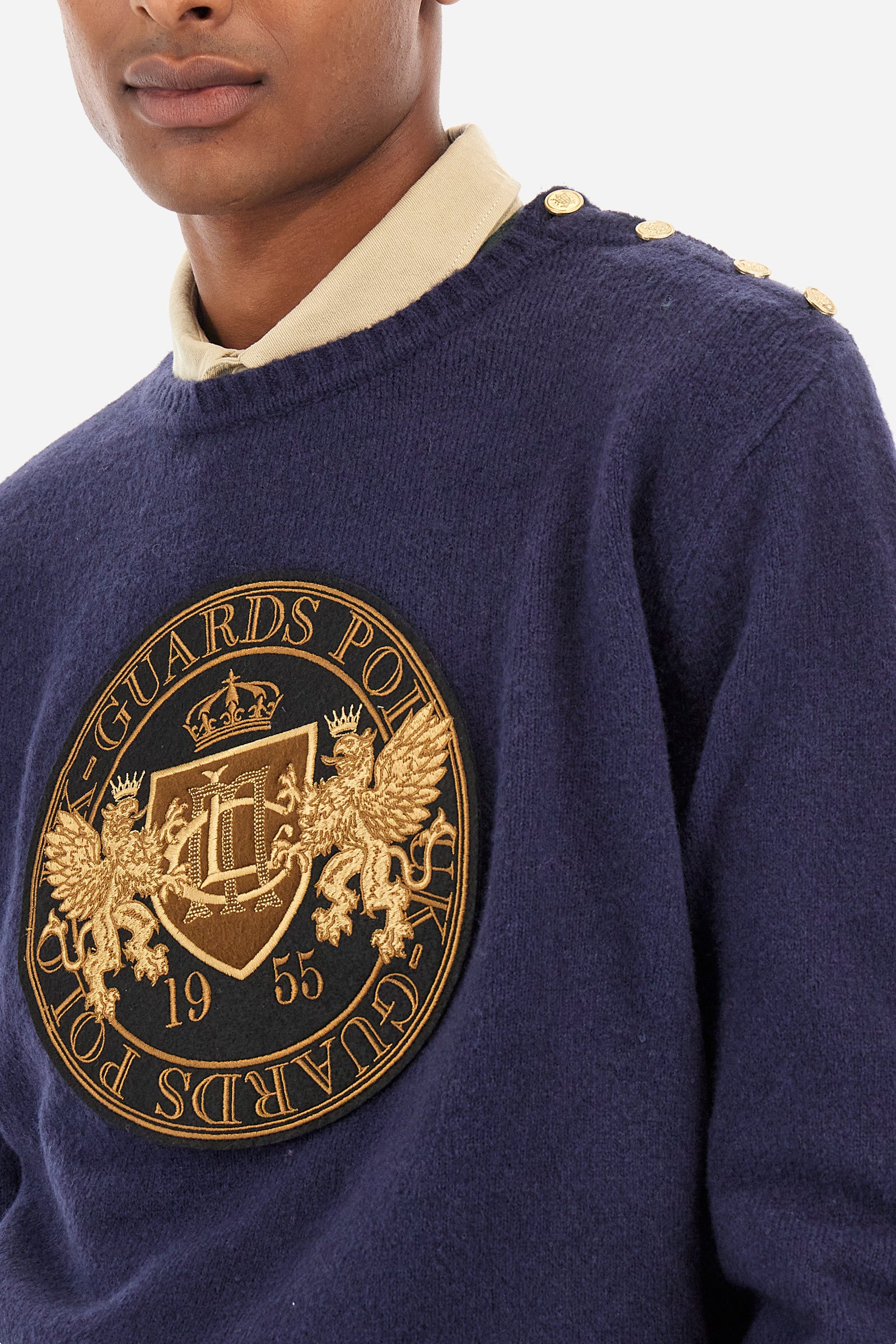 Men’s sweater with long sleeves with crew neck, solid color regular fit. Made of merino wool, it features a large gold embroidery on the front that recalls the Guards capsule. Golden buttons applied on one shoulder and the drawstring at the waist make the garment elegant and perfect for formal outfits or to give a more refined touch. The model is 187 cm tall and wears a size L. - Navy