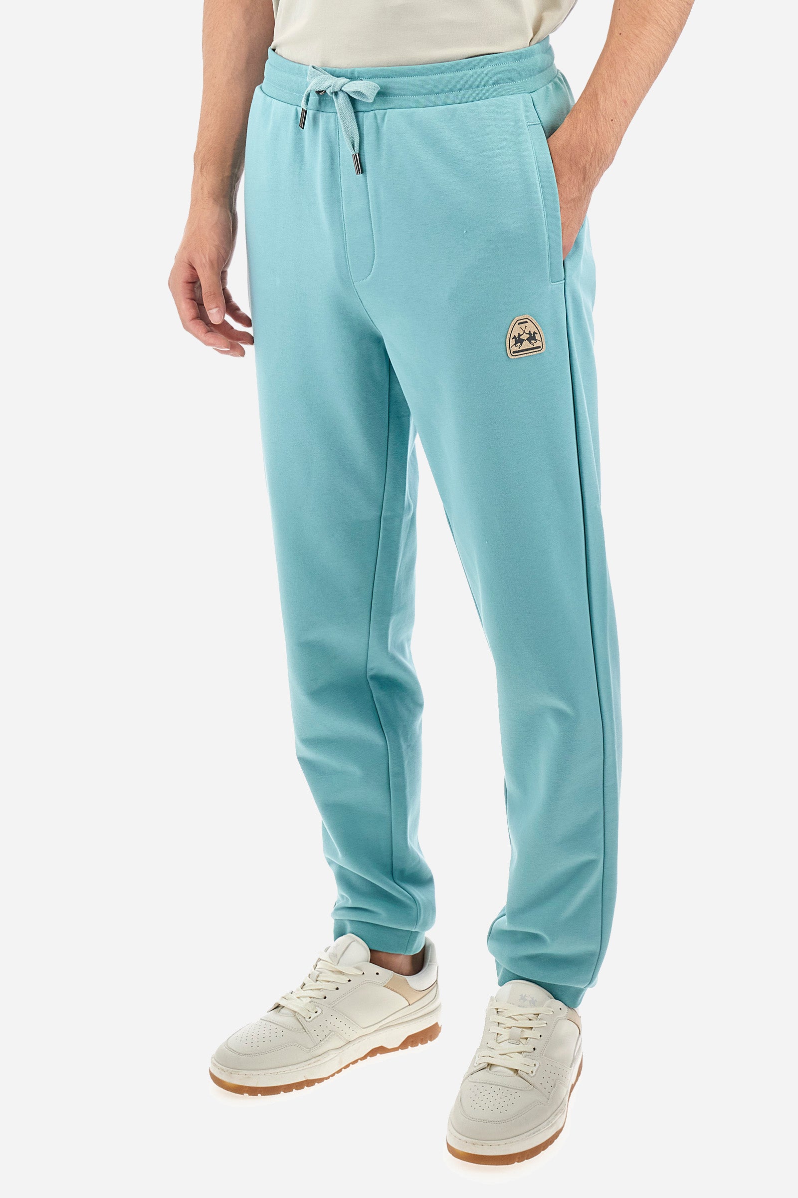 Men's single-colour jogging bottoms in a cotton sweat fabric from the Polo Academy line. With a drawstring waist and double front pocket. Another pocket is present on the back. The logo is present on a patch applied under one of the front pockets. The fit is regular. The model wears a size L. - Aquifer