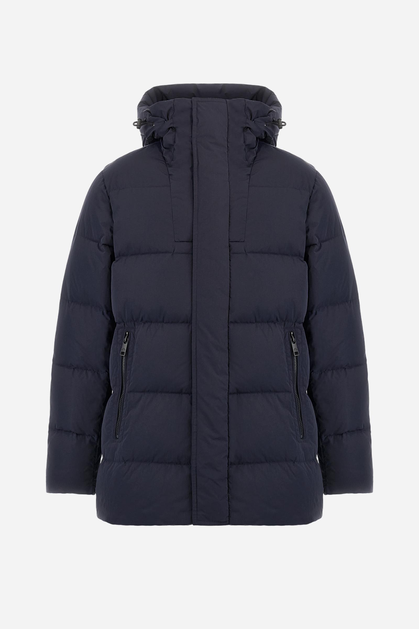 Men's long down jacket in solid crinkled nylon with detachable hood. Filled with down and fully lined in contrast, designed to provide warmth and lightness. The removable hood is adjustable with elastic drawstrings. Double zip closure with exclusive carabiner puller. Inside placket features contrasting La Martina embroidery, while a logo patch on the left sleeve completes the garment. Designed to combine urban functionality with technical performance. Regular, comfortable fit. Model wears size L. - Navy