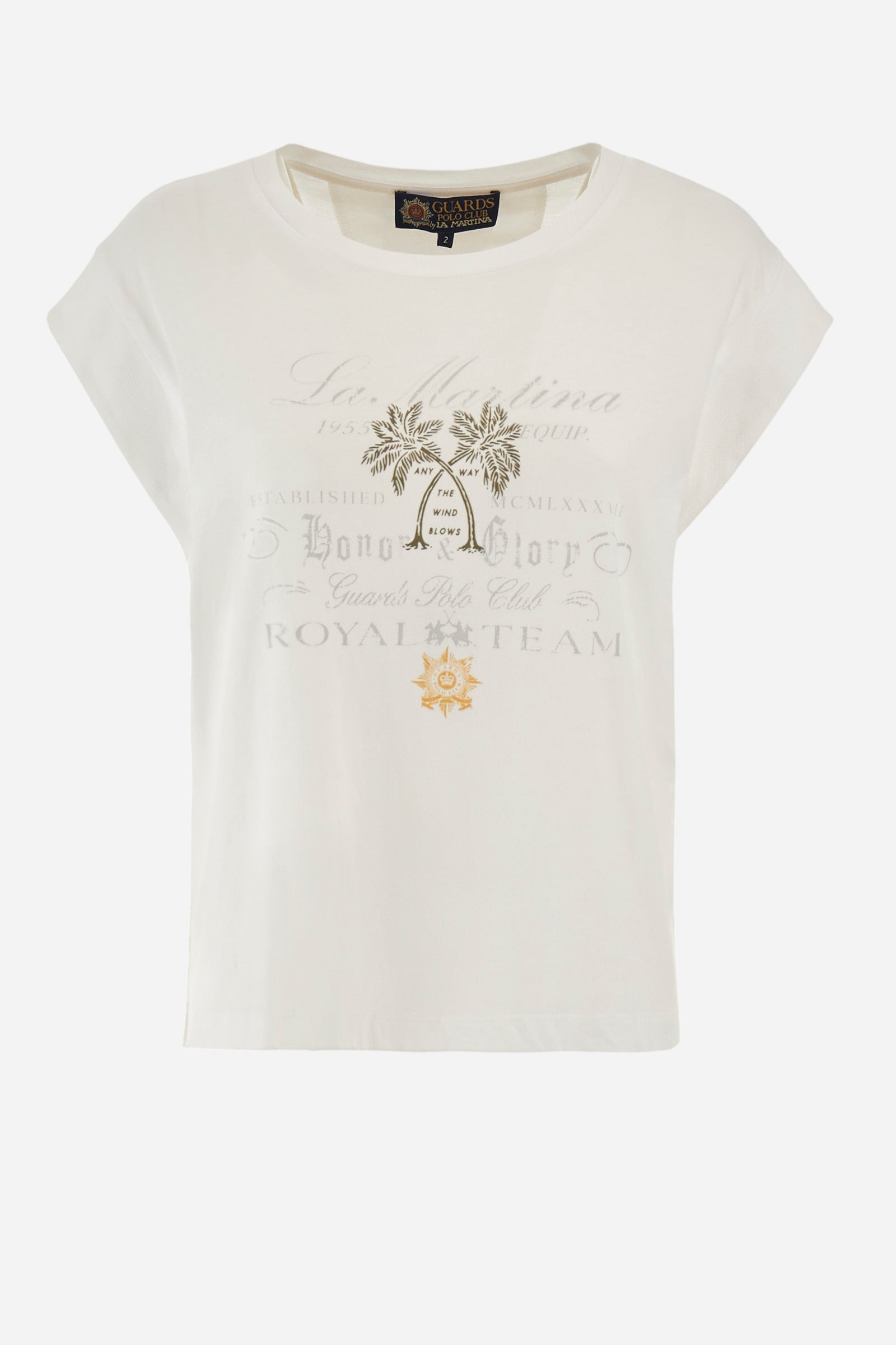 Women’s crew neck short-sleeved t-shirt in solid color, made of 100% cotton jersey. On the front we find an embroidered mini logo La Martina together with the symbol of the capsule collection Guards, in contrasting tone, which are accompanied by palm prints. Two mini side slits. The fit is regular. The model wears a size 2. - Optic White
