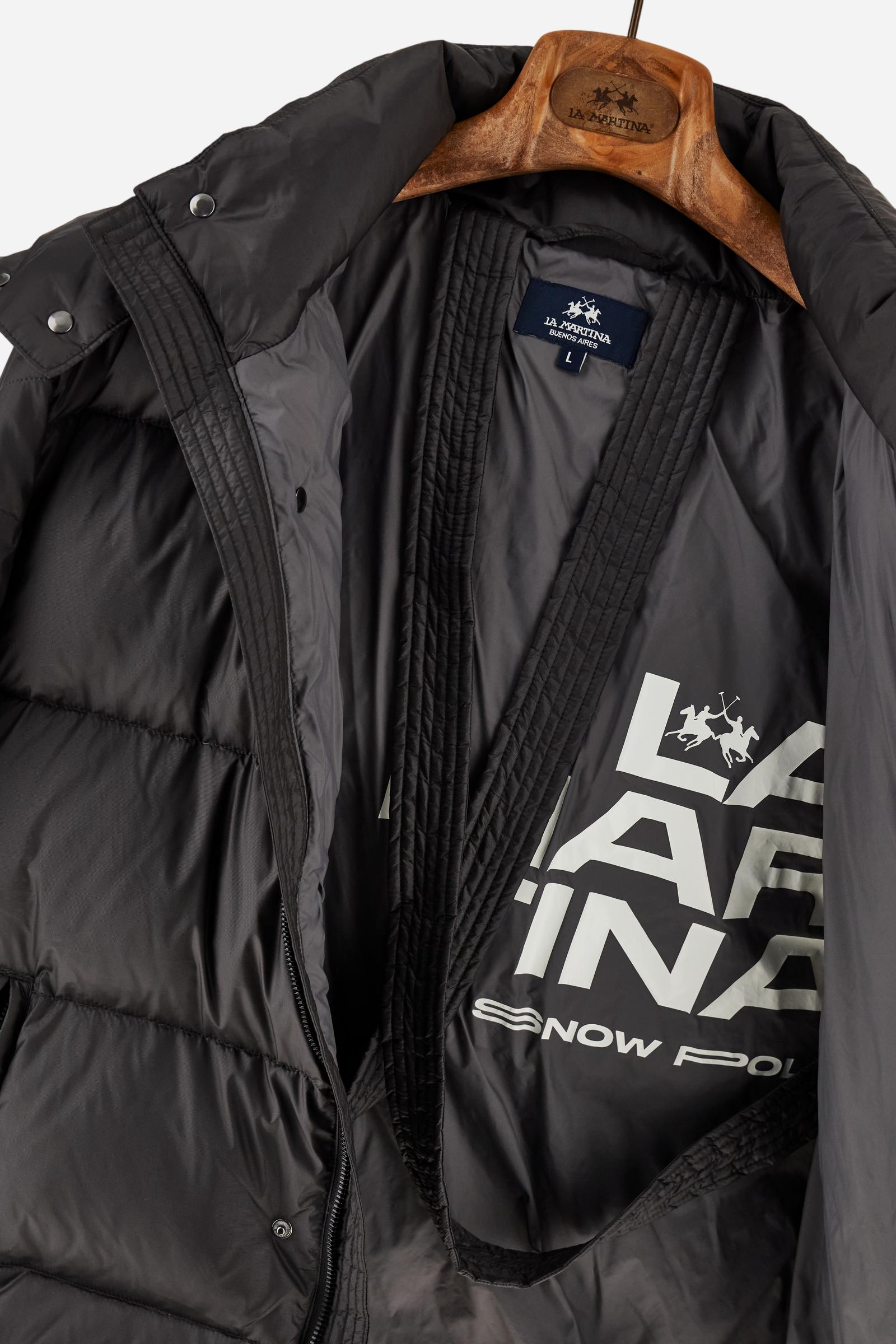 Men’s padded bomber jacket with detachable hood. Made of solid iridescent nylon with contrast lining. Equipped with two practical inner braces for extra comfort. Double customized zip front closure with inner placket featuring contrast Polo Player print, closed with metal snap buttons. Two vertical zipped pockets on the front. Hood with contrast lining and adjustable elastic drawstring. Bold Polo Player graphics printed inside. Regular fit for comfortable movement without bulk. Model wears size L. - Black