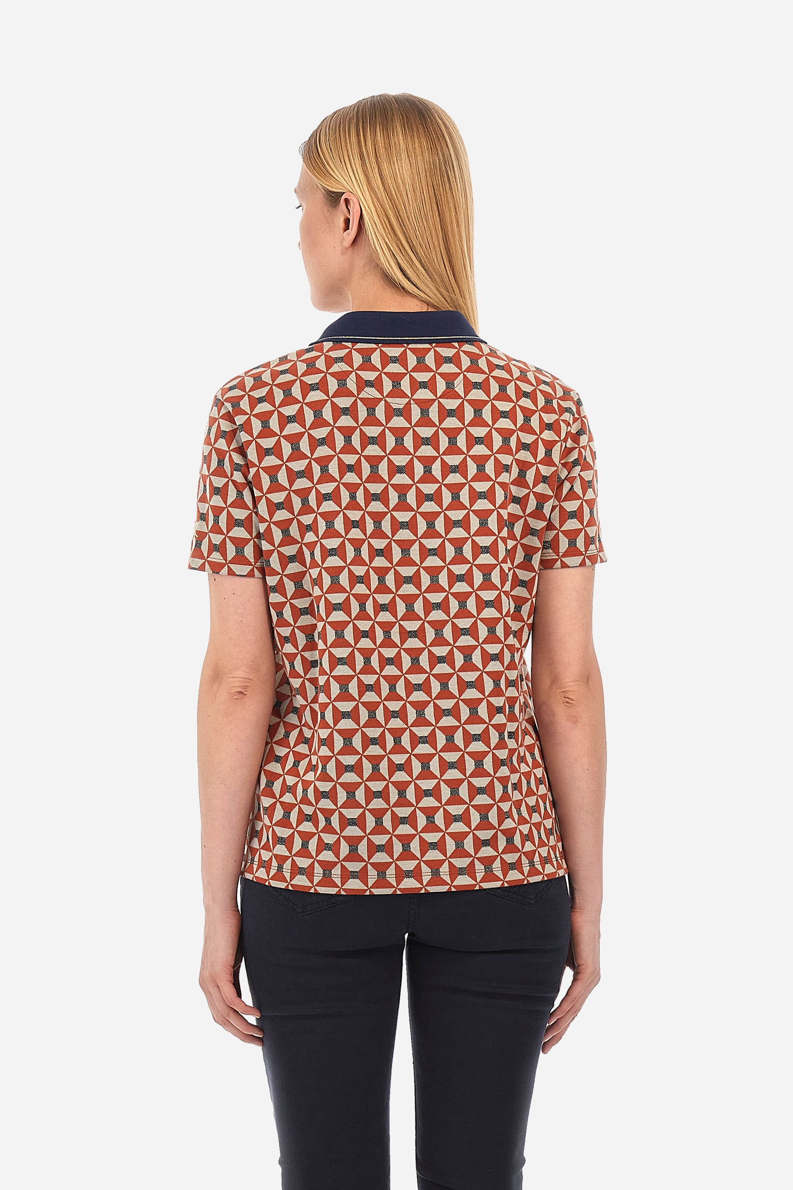 Women’s polo with short sleeves in multicolor geometric pattern of the Polo Academy line. Made of jaquard plush material. V-neck with double jewel button closure. Collar and ribbed and contrast neckline. The logo is sewn on one of the sleeves. The fit is regular. The model wears a size 2. - CINNABAR/NAVY/BONE W