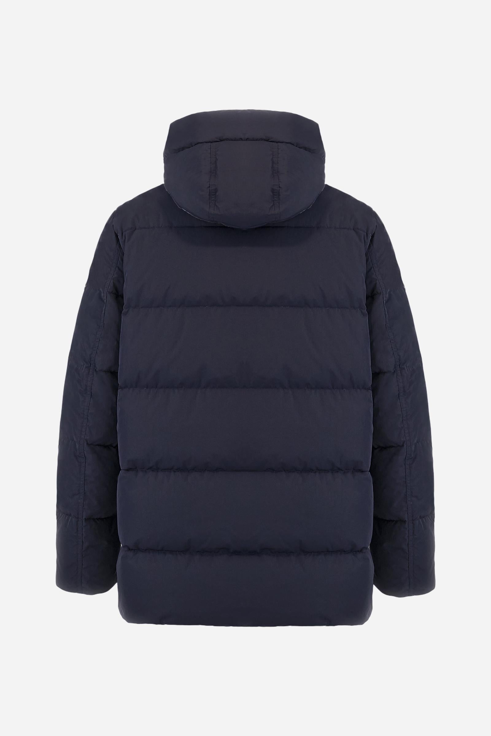 Men's long down jacket in solid crinkled nylon with detachable hood. Filled with down and fully lined in contrast, designed to provide warmth and lightness. The removable hood is adjustable with elastic drawstrings. Double zip closure with exclusive carabiner puller. Inside placket features contrasting La Martina embroidery, while a logo patch on the left sleeve completes the garment. Designed to combine urban functionality with technical performance. Regular, comfortable fit. Model wears size L. - Navy