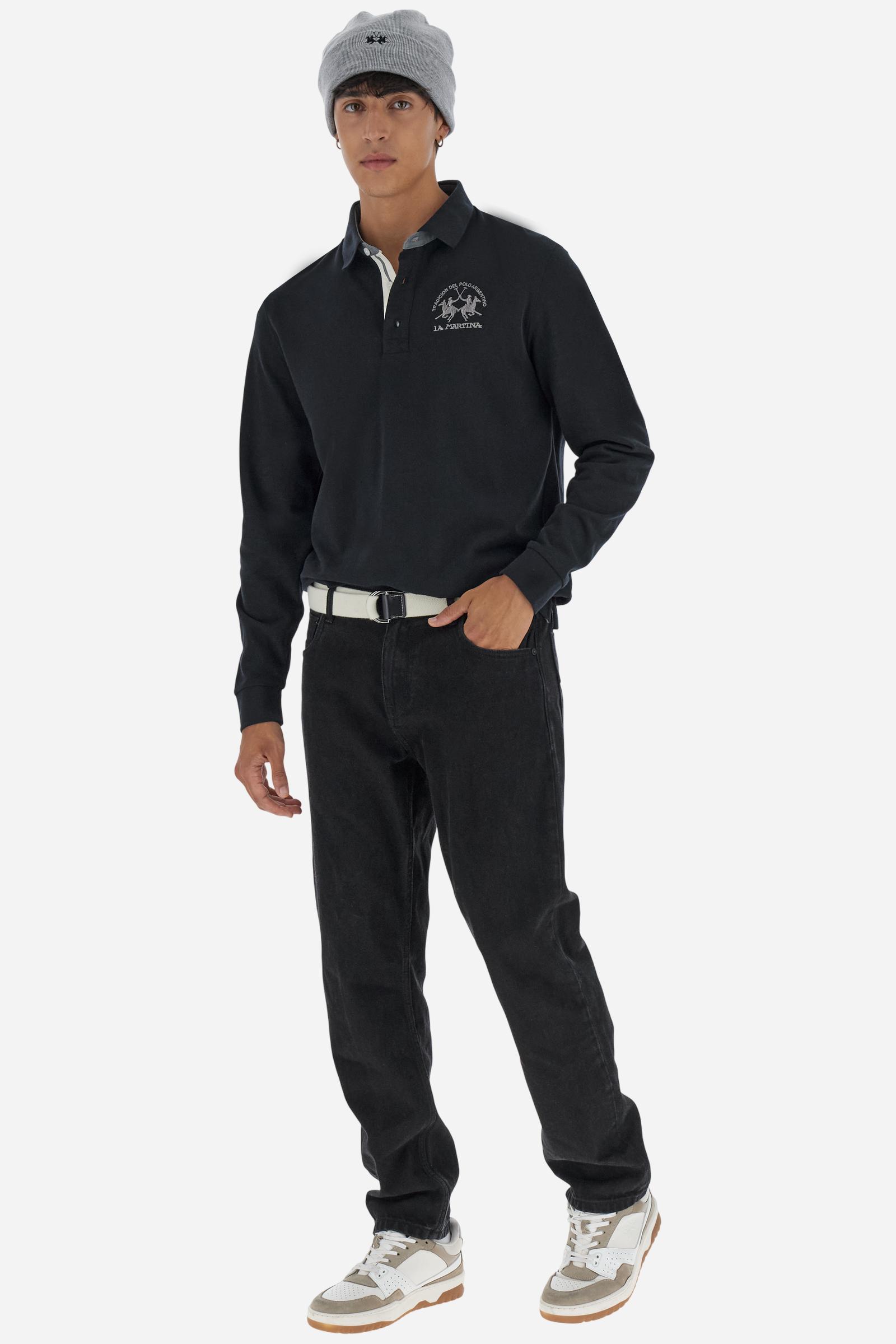 Classic men’s long-sleeve polo in soft-touch 100% cotton jersey. Contrast gabardine collar, three-button placket with multicolor striped tape. Iconic La Martina lettering printed in contrast under the collar. Small contrast logo embroidered on the chest. Regular fit for a balanced silhouette. Model wears size L. - Black