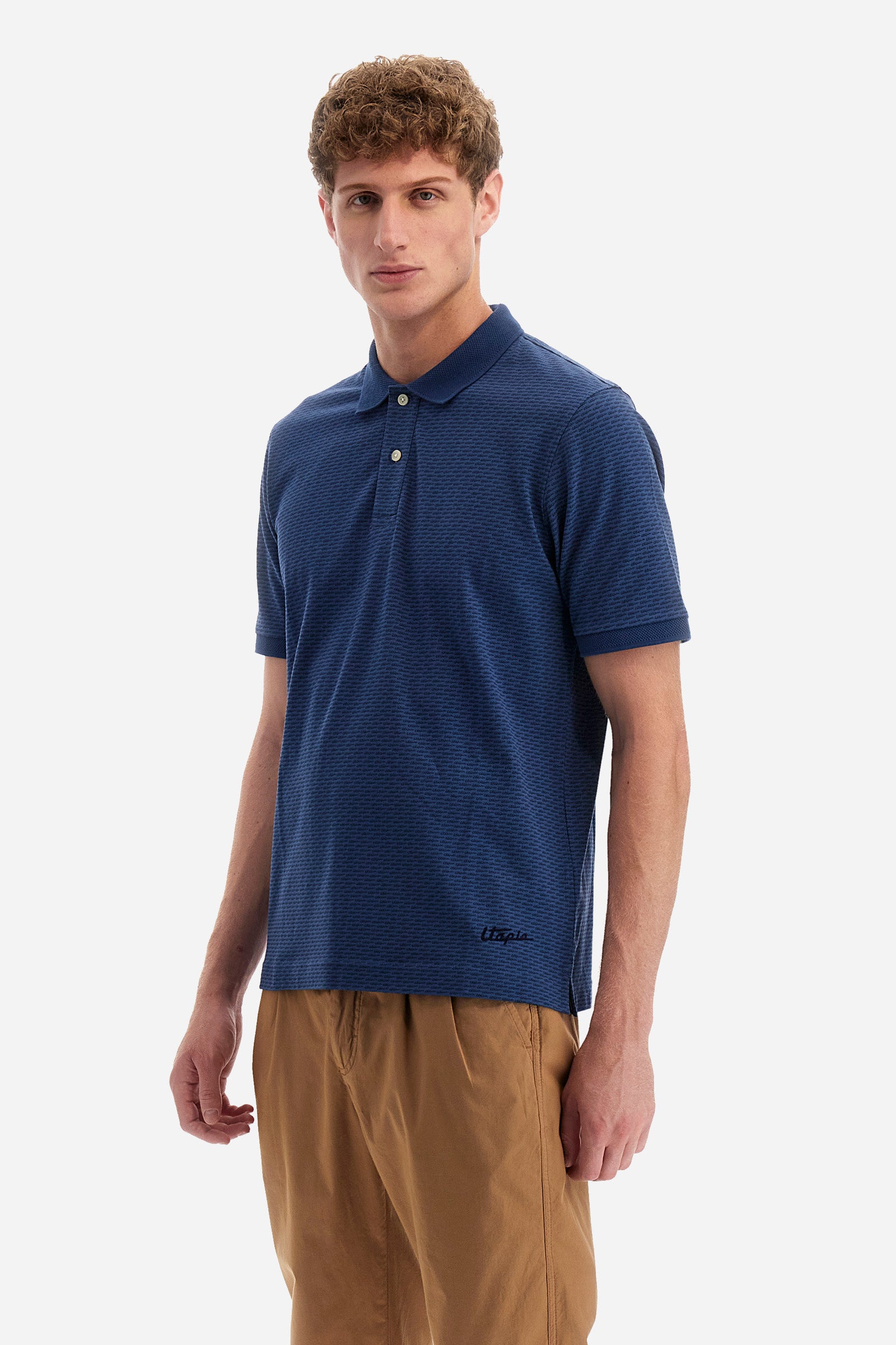 Single-colour men's polo shirt with short sleeves from the line in collaboration with Pagani. Made of stretch cotton. Two-button fastening. The collar and armholes feature a different texture. The garment features lettering throughout. A patch with the brand's name and logo and the word "Pagani" is applied on the back. The fit is regular. The model wears a size L. - ENSIGNBLUE/NAVYBLAZE