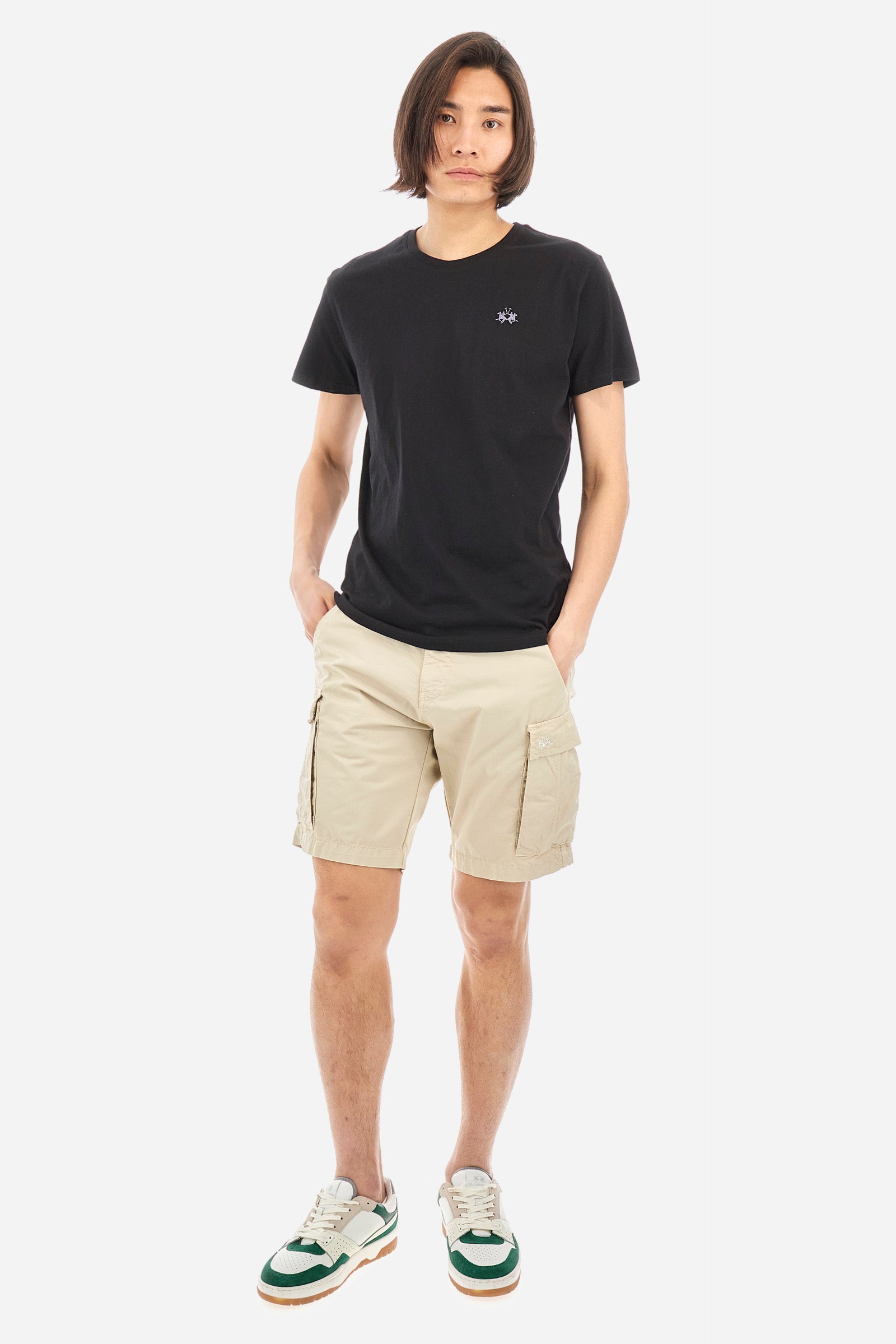 Men's short-sleeved crew-neck T-shirt in solid colour with embroidered logo in contrasting colour on the chest. Made of 100% cotton with a regular fit. It is perfect paired with Bermuda shorts or trousers for a casual and trendy look. Suitable for leisure time. The model is 187 cm tall and wears a size L. - Black