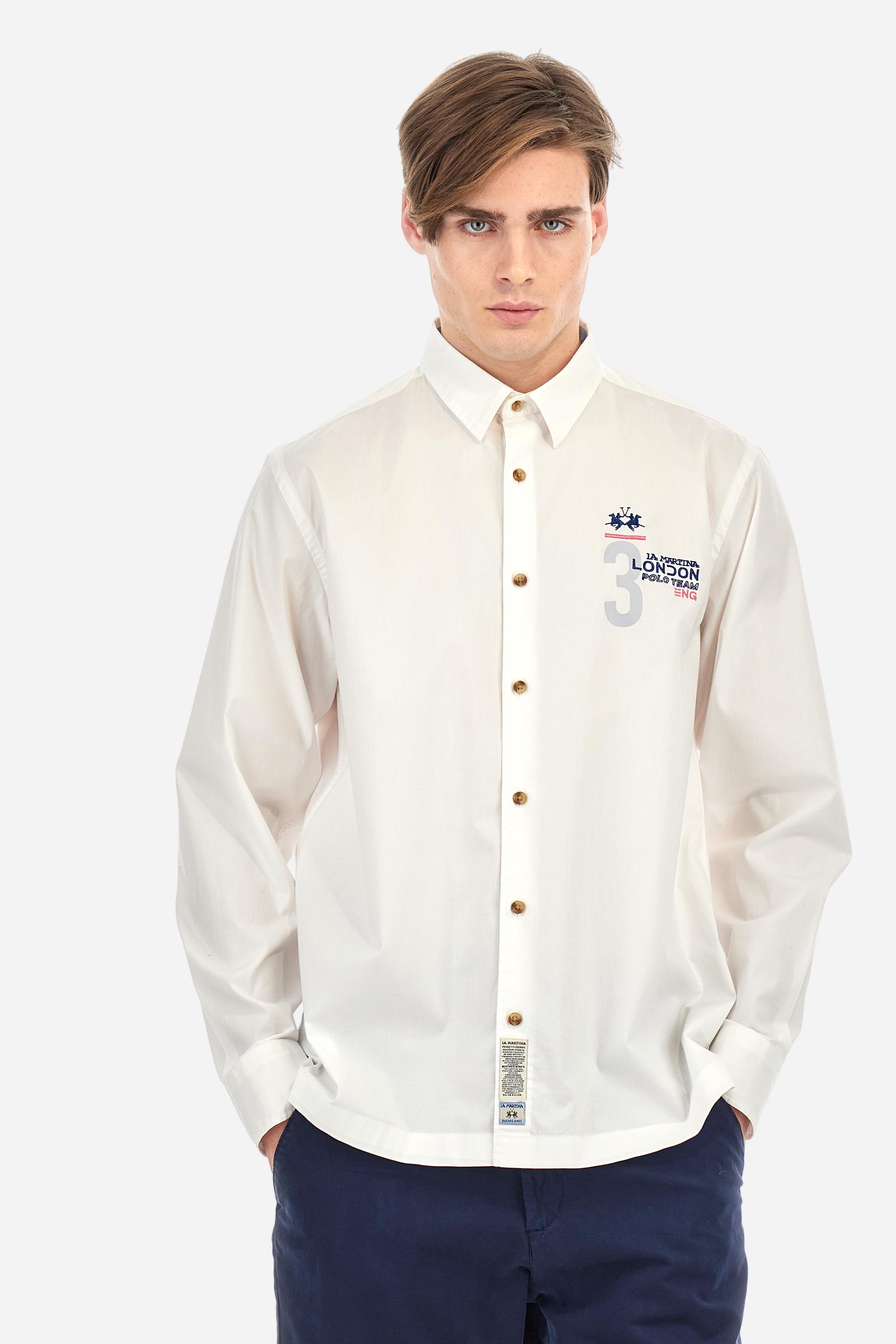 Men's single-colour long-sleeved shirt, made from 100% cotton poplin. Spread collar. Contrasting printed fabric details on the inside of the collar and opening. The numbers on the chest and back graphics are rubberised prints, while the rest of the graphics are embroidered. The logo and La Martina lettering is embroidered on the left chest. The fit is regular. The model is wearing a size L. - Optic White