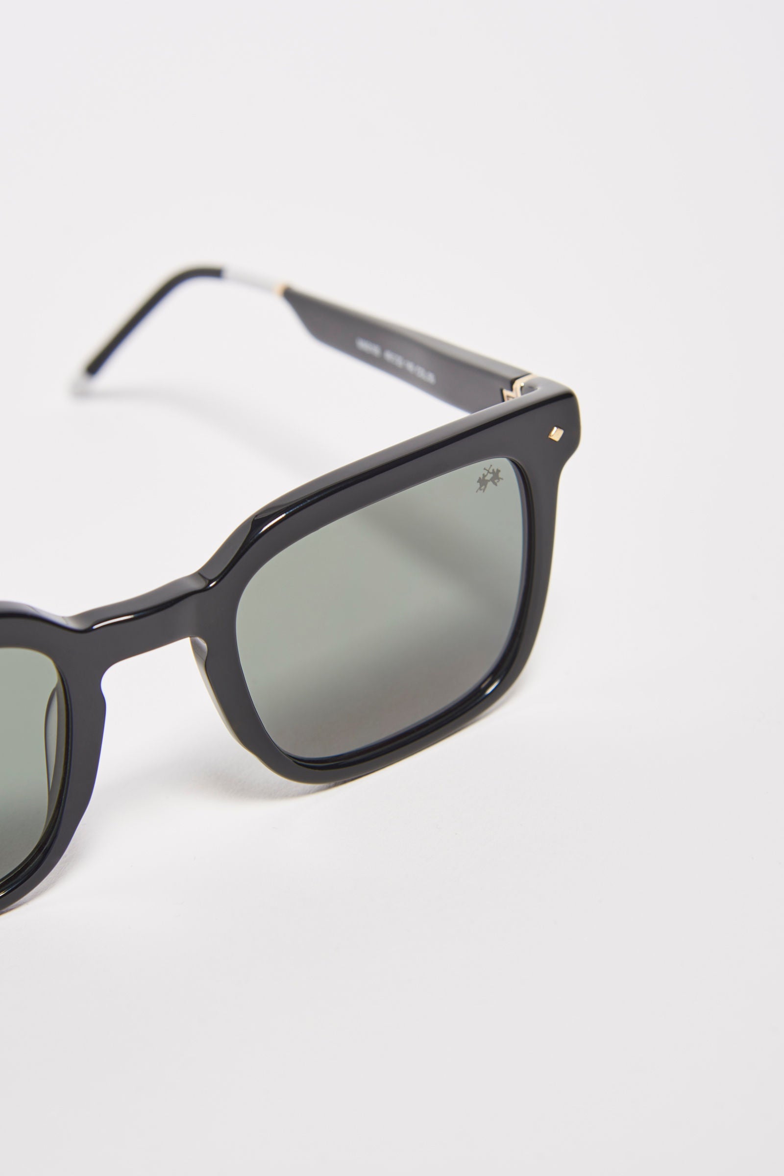 Men's squared sunglasses in acetate material. This classic style model features a small La Martina logo on the temple and lenses with internal blue anti-reflection. The light black frame makes it easy to wear, while the coloring allows you to wear the glasses with any look and always be fashionable. - BLACK