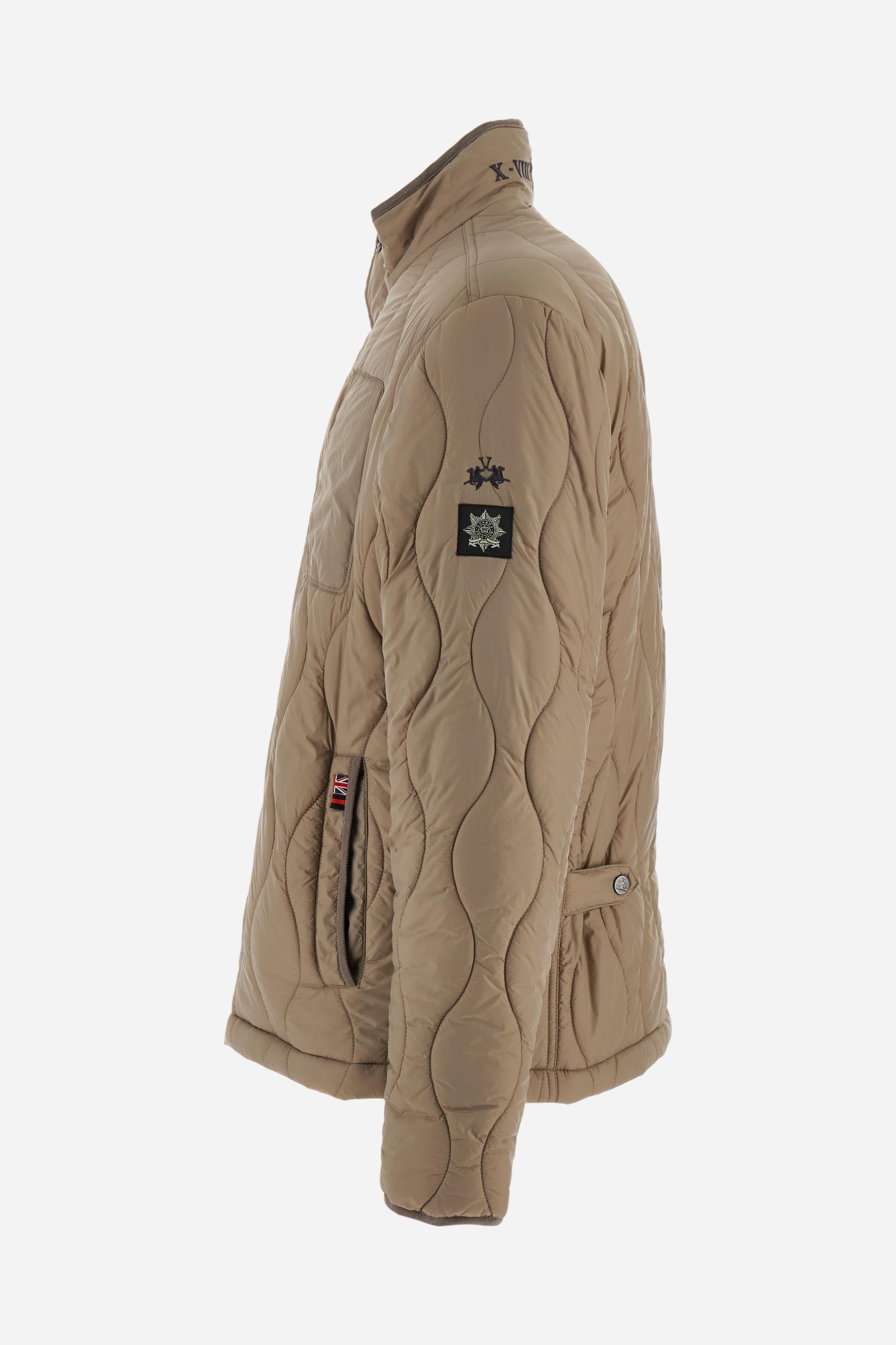 Men’s quilted nylon husky jacket with high collar. Front closure with customized zip and large faux-leather buttons. Interior lined with striped bicolor polyester. Contrast details on the inside (pockets, profiles, back-neck tab). Clean design with chest pocket closed by zip and vertical side pockets. Adjustable back straps with metal snap buttons. Logo patches on the sleeves and multicolor embroidered lettering on the outer collar. Part of the Guards capsule. Regular fit. Model wears size L. - Moon Rock