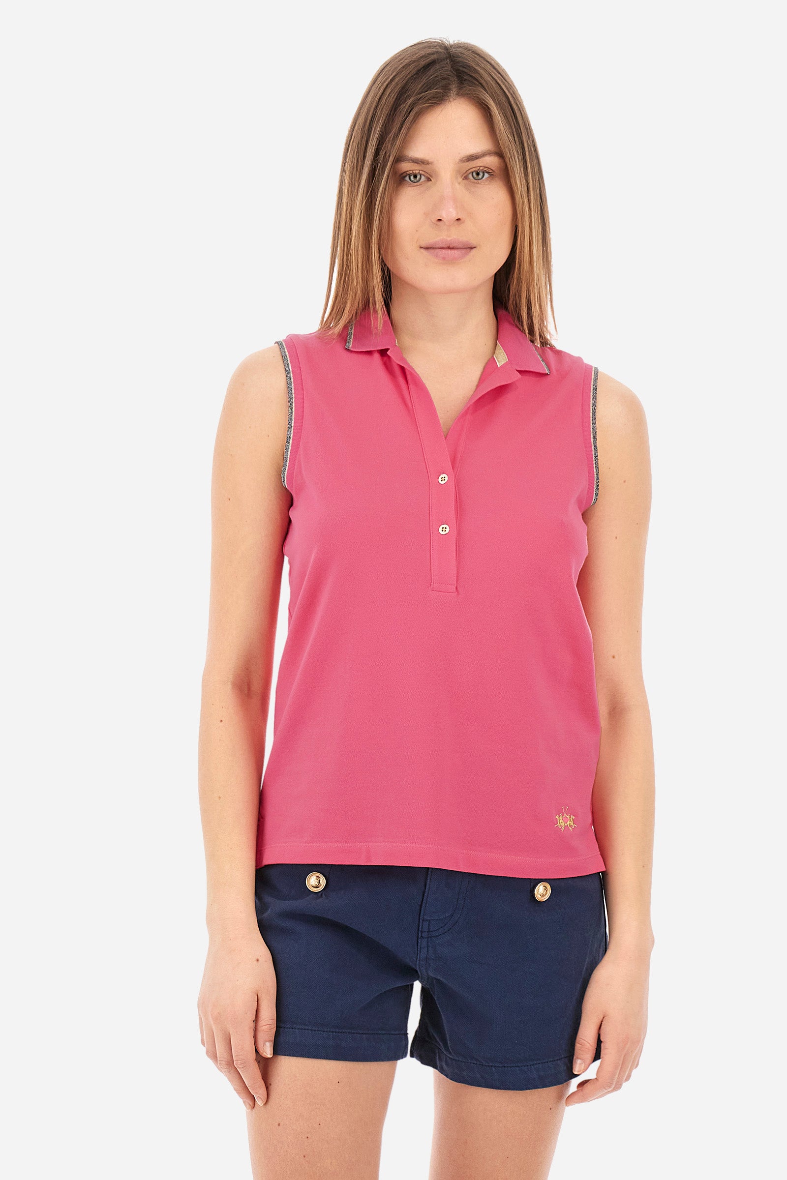 Women’s sleeveless polo shirt in solid color, made of stretch cotton. V-neck and 2 button closure. Collar and crew sleeves profiled and ribbed. Side slits. On the back there is the inscription "La Martina" composed of small rhinestones. The logo is present on the front. The fit is regular. The model wears a size 2 . - Hot Pink