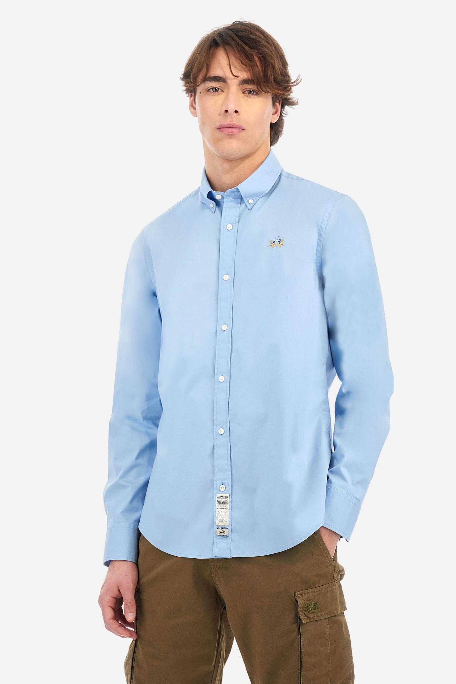Men's plain long-sleeved shirt made from stretch cotton poplin for a comfortable fit. Featuring a button-down collar and woven labels at the bottom of the opening. A multicoloured logo is embroidered on the chest, over the heart, in contrasting thread. The slim fit ensures a sleek and modern look. The model is wearing a size L. - Blue Bell