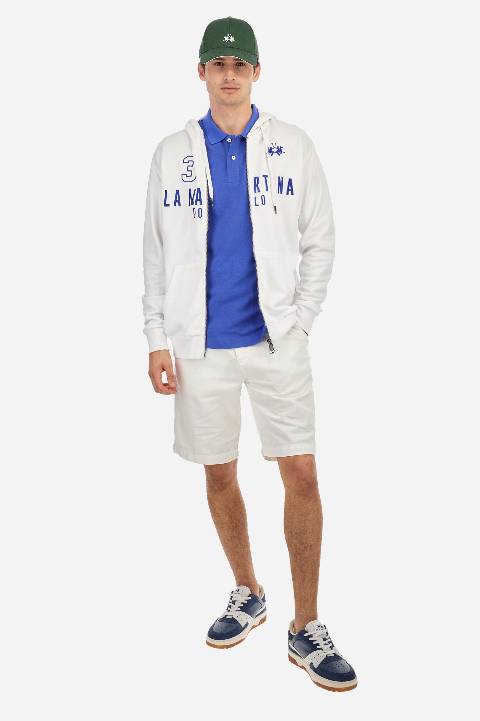 Men's long-sleeved plain sweatshirt made from French terry cotton. Full-zip fastening and hood with adjustable drawstring. On the chest, the La Martina Polo lettering is present as a large, slightly embossed embroidery, while the number 3 is present as a patch made of the same fabric and applied with an embroidered cord in a contrasting colour. The logo is embroidered on the chest, left side. Regular fit. The model is wearing a size L. - OptWhite/Surf TheWeb