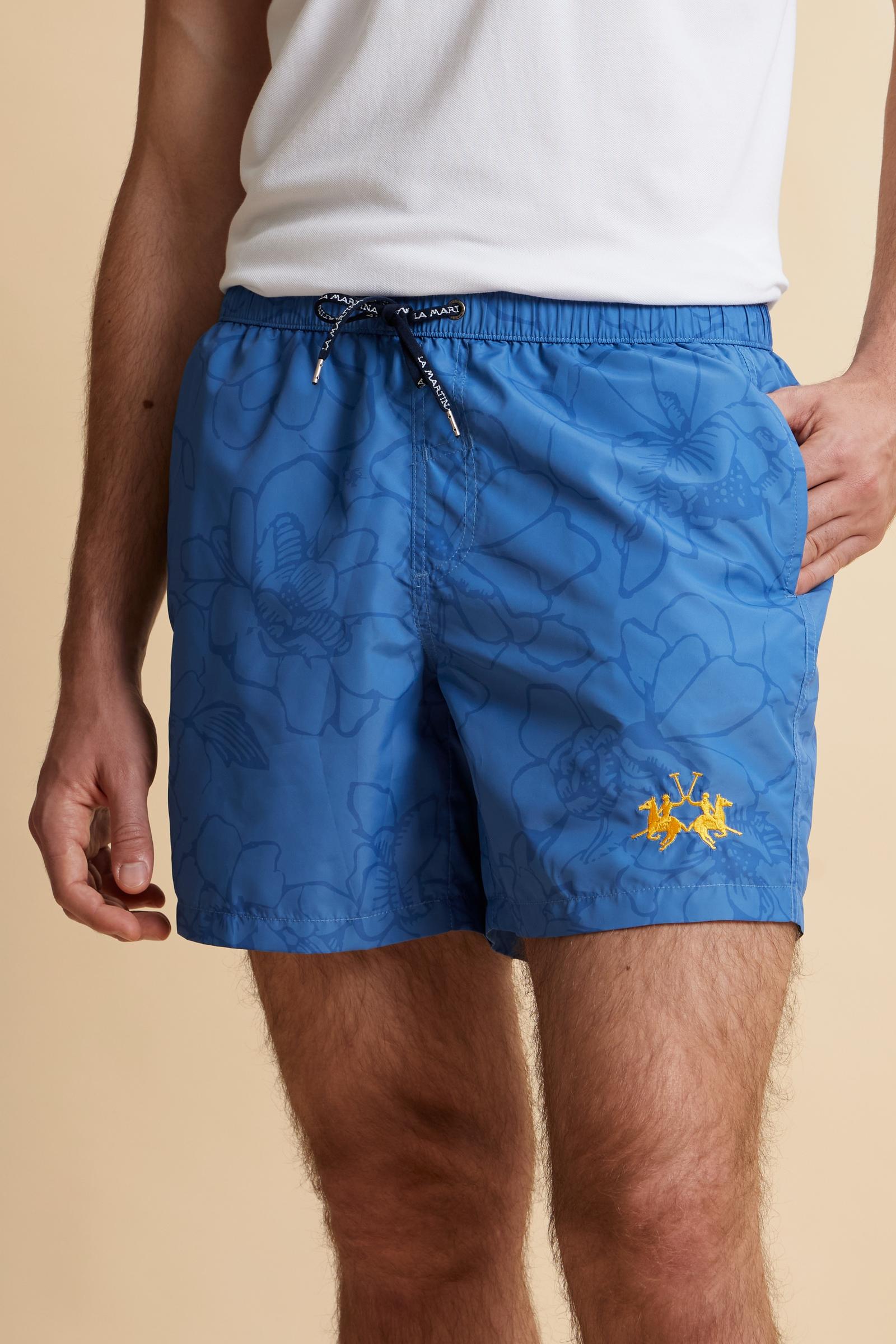 Men’s nylon swim shorts with floral print. Mid-length design with elasticated waistband, drawstring and contrasting embroidered logo. - Riviera/Dutch Blue