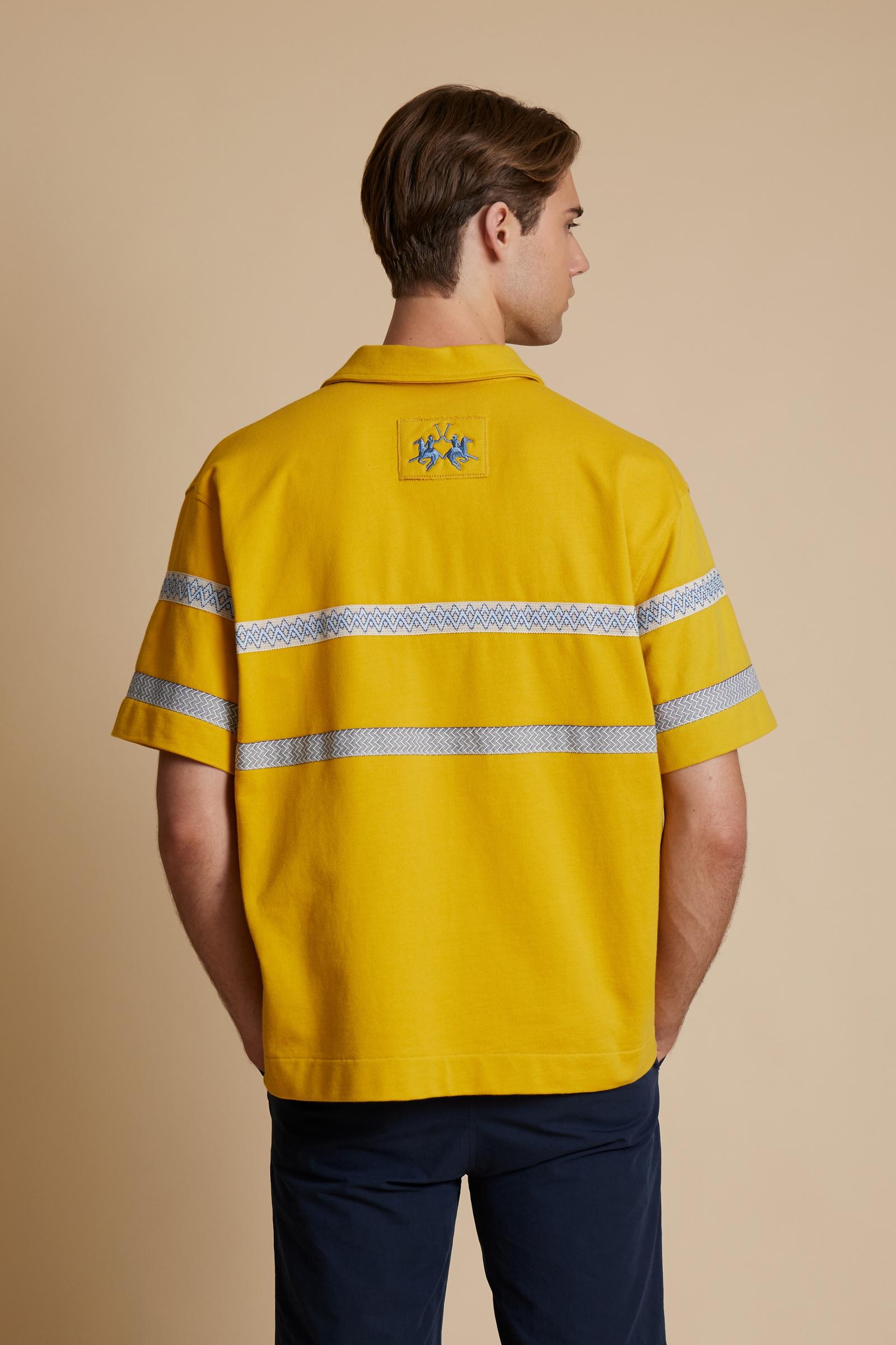 Short-sleeve polo in heavy cotton jersey with a compact structure and substantial hand feel. Contemporary fit with relaxed volume and slightly dropped shoulders. Classic collar with visible placket and bold horizontal band with geometric multicolor tapes. Raised “La Martina” embroidery on the chest and contrasting 3D logo on the back. - Tawny Olive